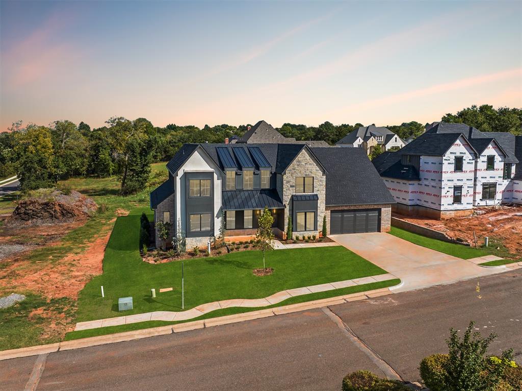 Showcasing exquisite design in Autumn Ridge! This property provides everything one could want out of modern luxury living: tranquil surroundings enhanced by stunning views, plus thoughtful design elements that combine comfort and convenience that will exceed your highest expectations! The main level boasts a spacious Grand Room with high ceilings, and the kitchen is perfect for entertaining as it can accommodate not only multiple cooks but also mingling guests. Featuring butlers panty, custom cabinetry, and top of the line appliances. Escape to the extra large primary suite at the end of a long day. The primary suite is a sanctuary of comfort, spa-like bath with a walk-in shower, free-standing tub, double vanities, all near the utility room for ultimate convenience. It is complete with a bathroom fully appointed to pamper even the most discerning owners. Don't miss the amazing closet. The upper level houses 2 bedrooms & 2 full bathrooms, as well as an additional bonus room/game room. This home features only the highest-end designer finishes. The outdoor living space is a haven for relaxation and entertainment, perfect for enjoying those tranquil evenings. Details in this home has been carefully selected, from designer lighting to premium tile work and a neutral color palette, ensuring the interior design complements any personal style with elegance and functionality. Whether you're entertaining guests or enjoying a relaxing day with family, the endless hours of fun and entertainment are yours to enjoy in this luxury estate. Showing times available for your private tour. Welcome Home!