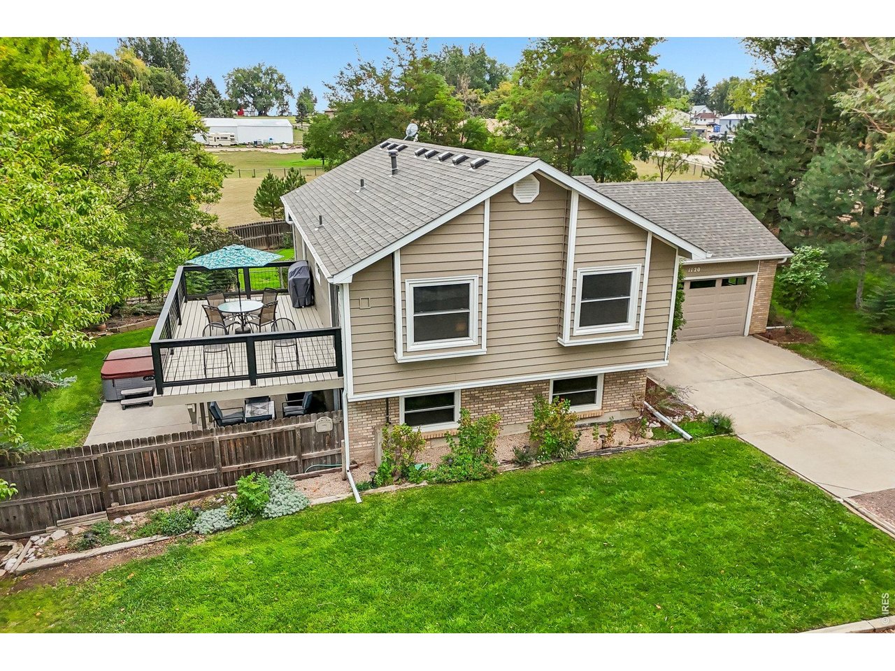 Discover the best of Colorado country living on this rare, flat 2-acre property tucked down a quiet country lane w/ front range views, privacy, & no HOA. Originally built in 1988, this thoughtfully updated home features many recent improvements. The open-concept main level welcomes you w/soaring ceilings, newer luxury vinyl flooring, & west-facing windows framing spectacular mountain views.The spacious living room flows seamlessly into the dining area & refreshed kitchen, featuring custom solid cherry cabinetry w/soft-close hinges & drawers. The main-level primary suite offers a private full bath & charming Dutch-door entry. A flexible bonus room,currently an office,could easily be converted back to a 3rd bedroom.The garden-level walkout offers a second primary suite w/beautifully remodeled 2026 bath & direct access to the private backyard and patio. Relax in the included hot tub or unwind in the lower-level family room w/ a remote-controlled, Jotul cast-iron propane heater. A fully insulated sunroom/studio w/A/C & 220V wall heater with day/night temperature settings, & yoga-mat flooring provides the perfect space for hobbies, fitness, or creative pursuits. 2026 improvements include remodeled primary bath,new furnace, hot tub,refreshed main-level bath,new deck, garage door,& roof. Additional updates include HW heater 2021, A/C,2022, newer Champion,low E, double-pane windows, insulated siding, & new gutters. Enjoy multiple spaces for entertaining & relaxing, including a private patio w/fire-pit,large. There is a tool shed,& double gate opening to the fenced 2-acre pasture. Zoned for horses, the property offers exciting possibilities for equestrian living, subject to Larimer County requirements. The garage features built-in closets for added storage. Two primary suites, mountain views, extensive updates,walkout lower level,bonus spaces,& room for horses, this exceptional property offers a rare opportunity to enjoy privacy, flexibility, & Colorado country lifestyle.