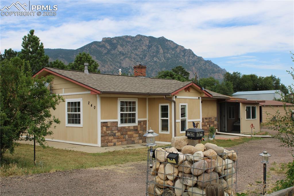 What a fantastic 1.33-acre property!  Cheyenne Mountain is visable from every angle and if you enjoy the outdoors, raising chickens, a greenhouse and just overall having fun on your property, you will love this rare opportunity.  The extras that come with it are plentiful - they include a tractor with 4 implements, a 2-axle trailer, a 24-foot 2019 model 5th wheel, a tiller for your fenced garden and a workshop that was used for woodworking with a vacuum system and air compressor. There are 2 separate hook-ups for RVs with electricity and septic and an underground cistern that you can pump water from for watering.  The side yard is very spacious and holds many possibilities for additional buildings OR this property is also zoned for horses.  The home is cozy with a pellet stove, A/C, wonderful hardwood floors and a very enjoyable sunroom.  If you'd like a little acreage, a daily view of Cheyenne Mountain, some peace and quiet just minutes to Ft. Carson and downtown Colorado Springs, don't miss this one!