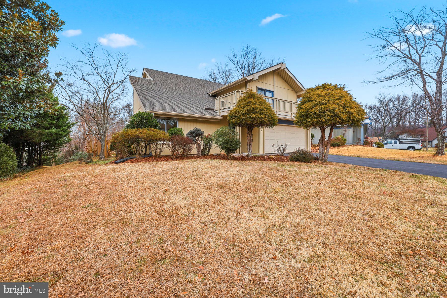 Welcome to this beautifully maintained 5-bedroom, 2 ½ bathroom contemporary home tucked away in a quiet West Springfield neighborhood. Backing to peaceful woods and offering privacy, this home strikes a gracious balance between quiet surroundings and daily convenience.Entering the front door, you are greeted by an expansive living room with vaulted ceilings and Pergo plank flooring, creating a bright and enveloping environment. The renovated kitchen, filled with natural light, features quartz countertops and stainless-steel appliances, opening to an inviting family room ideal for entertaining and everyday gatherings. A wood-burning fireplace provides the perfect spot for cozy winter evenings.  A tidy first floor laundry room gives direct access to the two-car garage.The upper level offers five bedrooms, including a large primary suite with vaulted ceilings, en-suite bathroom, and walk-in closet with adjustable shelves.  A shared hall bath serves the remaining bedrooms. On the first level, step outside to the large deck overlooking a private, open backyard with wooded area beyond, ideal for relaxing and enjoying nature. There are built-in garden beds as well as additional garden space alongside the home. A wooden fence, added in 2023, enhances privacy, and a built-in shed provides storage space for outdoor tools. Recent updates include fresh paint throughout (December 2025), an architectural roof (April 2025), carpet on both levels (2024), hot water heater (2022), washer (2025), dryer (2022), kitchen appliances (2021), and garage door opener (2025).Located in The Crossings Homeowners Association, this desirable community is zoned for highly ranked Cardinal Forest Elementary, Irving Middle School, and West Springfield High School, all within two miles. Excellent location just outside the Beltway with convenient access to Fairfax County Parkway and I-395/I-495/I-95.  Only a five-minute walk to Metrobus to the Pentagon. Also close to Franconia–Springfield Metro station, commuter lots, and the Virginia Railway Express (VRE) station to Washington, DC. Nearby are George Mason University, Lake Accotink Park, Burke Lake Park, Huntsman Lake, walking and biking trails, South Run Rec Center, Springfield Golf and Country Club, access to community swim and racquet clubs, and the Springfield Town Center. Three grocery stores, shopping, and a variety of popular restaurants and international cuisine are all within one mile.  Make your appointment today!