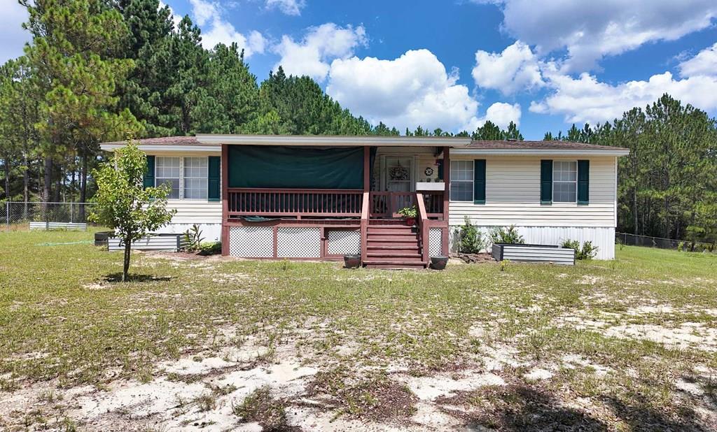 Welcome to your private retreat! This 4 bedroom, 2 bath home sits on 5.24 acres, offering plenty of room to spread out and enjoy country living. The home features an attached carport for convenience, plus a large detached shop that doubles as a 4-car garage; perfect for vehicles, storage, or hobbies. For those who love to garden, this property is a dream! It boasts a thriving garden area with specialty soil designed to enhance growth, along with 3 raised garden beds already filled with nutrient-rich soil to give your plants the best start possible. With space for family, gardening, and all your projects, this property has so much to offer. Don't miss the opportunity to make it your own!