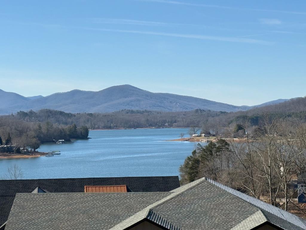 CAN'T DECIDE ON A MOUNTAIN VIEW OR A LAKE VIEW? The Cottages at Chatuge offers both! This .52-acre lot boasts of a heavenly view of Lake Chatuge while surrounded by Mountain Vistas. It comes ready-to-build on a recently graded lot that offers all utilities including paved roads, fiber optic internet, power, community water and sewer. HOA fees cover the community water, sewer system, road  maintenance and even year-round lawn maintenance of your lot! Perfect for a full-time or seasonal homeowner. Initial site prep and tree clearing has been completed and building plans, specifically designed for this site, are available upon request, making it easy to move from vision to construction. This upscale community also provides easy access to the public boat dock on Lake Chatuge located directly across the street, perfect for boating, fishing, kayaking, and swimming on those long, hot summer days. Outdoor enthusiasts will love the lifestyle of the mountains w/endless opportunities for hiking, camping, and exploring. Take advantage of the wonderful proximity to nearby boutiques and restaurants just minutes away in Hayesville, Murphy and Hiawassee, Ga.! Member of Freedom Boat Club? Choose from several nearby lakes to explore in the North Ga and Western NC. This lot offers everything everyone is looking for in a mountain get-away! Do not miss the chance to build your dream home in this exclusive subdivision that offers scenic views, modern infrastructure, and immediate access to Lake Chatuge! This one truly won't last...