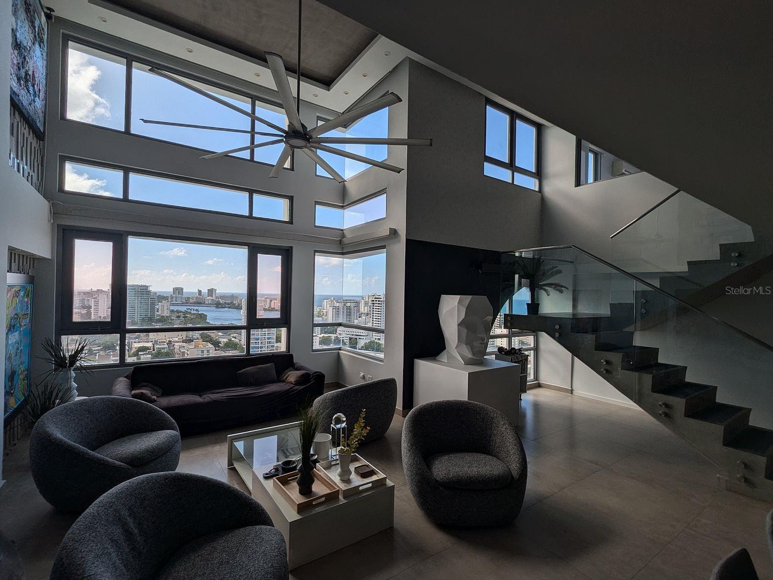 Art-Deco loft-style penthouse at Metro Plaza Towers in Santurce, steps from Condado. Built for entertaining. The fully covered terrace has a complete second kitchen and bar, plus an 8-person jacuzzi facing the water and full storm shutters that can completely enclose the terrace, with open views across the lagoon to the Atlantic. About 2,400 sq ft of interior living on two levels plus an approximately 1,100 sq ft private terrace with jacuzzi and city and ocean views. 3 bedrooms, 3 baths, 2 parking spaces, generator and cistern. Cash buyers only; serious inquiries with proof of funds. Offered as an entity sale for a fast close. Tenant lease runs through 12/31/2026: take ownership now and collect rent, or occupy after the lease ends. Photos were taken before the current tenancy; artwork, furniture and furnishings can be included, and the unit can be restored to the style shown. Motivated seller relocating, priced accordingly; all reasonable offers that can close quickly will be considered.