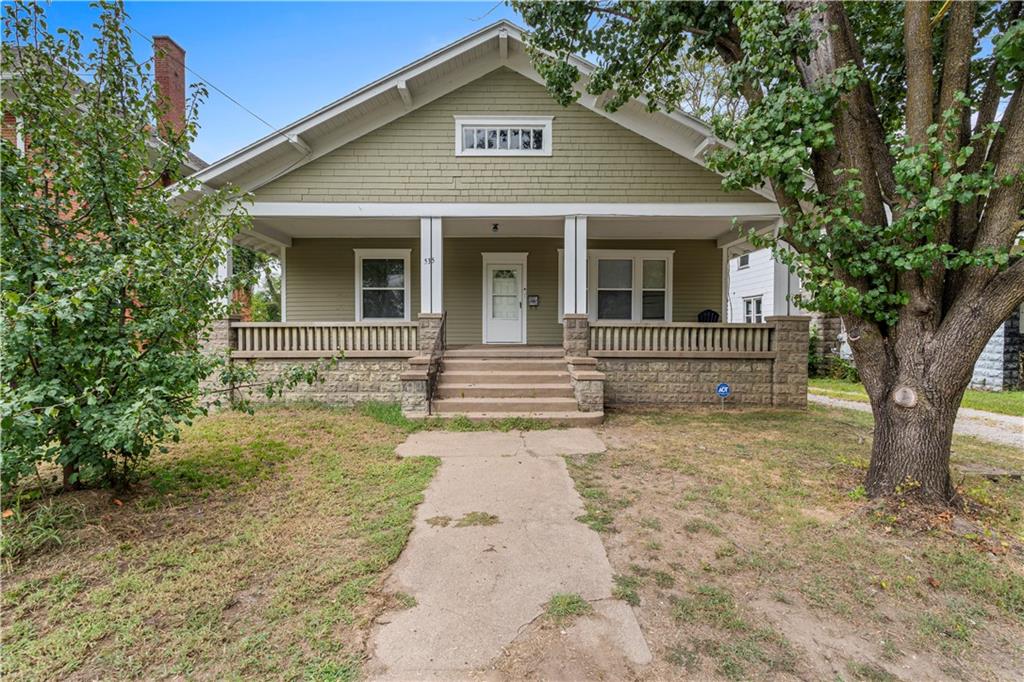 Offering over 2,000 sq. ft. of living space, this inviting home blends classic character with modern updates. A wide covered porch welcomes you inside to a spacious living room with hardwood floors, abundant natural light, and a cozy stone fireplace. The dining area is accented by wide trim and built-ins, while fresh interior paint and new flooring in the kitchen and baths give a refreshed feel. The kitchen offers abundant storage with built-in cabinetry, a china hutch, and a bonus storage room. The oversized master bedroom is lined with windows, and main-level laundry adds convenience. Updates include central heat and air (less than 4 years old) and a 3-year-old architectural roof. The backyard has a fenced section for pets or play, with parking available off the shared driveway or on the street. A full unfinished basement provides maximum storage. From cozy evenings by the fire to sunny afternoons on the porch, this home offers space, charm, and comfort. Call the listing agent today to schedule your tour!