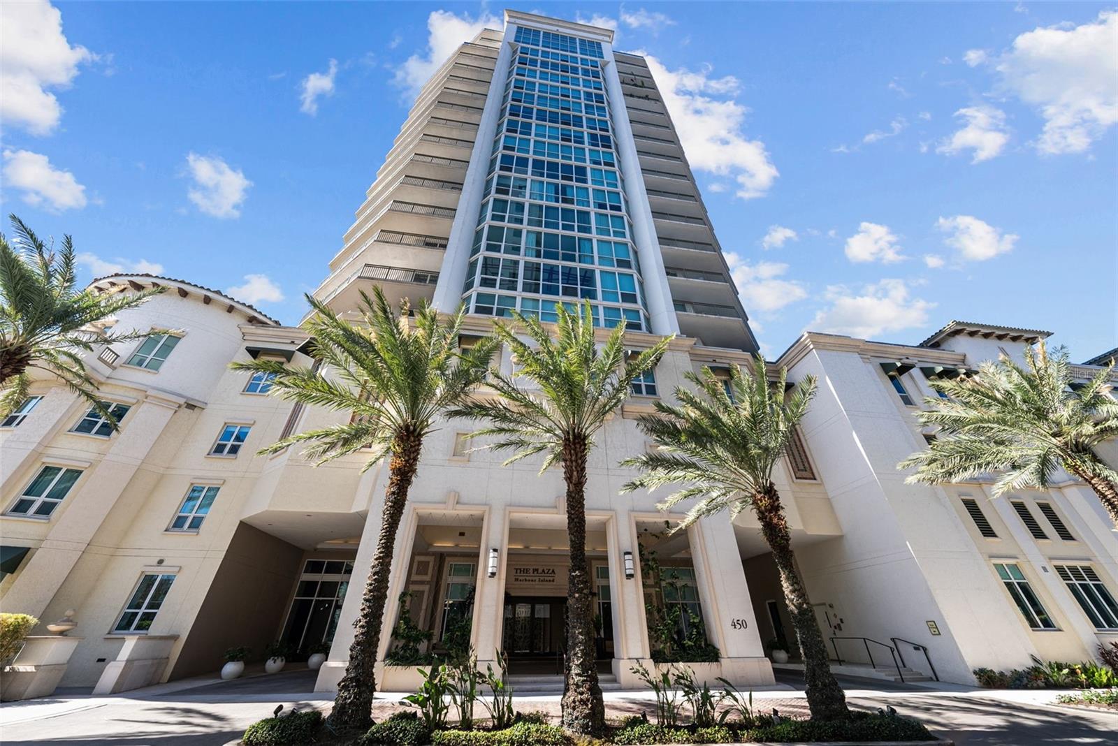 Welcome to 450 Knights Run Ave Unit 104 in The Plaza on Harbour Island — a stunning two story luxury brownstone-style residence blending elegance, comfort, and modern amenities. This home offers the perfect sanctuary with all the upscale features one expects from The Plaza community.

Step inside to discover two spacious bedrooms and two and a half bathrooms, thoughtfully upgraded to maximize style and functionality. The residence boasts light and bright features throughout. The gourmet kitchen features an oversized quartz island with a waterfall on both sides and an inner section, perfect for entertaining or everyday living. All appliances are approximately a year and a half old, used sparingly and in excellent condition.

Recent upgrades include a new Trane AC system ensuring optimal comfort year-round, new electrical wiring for recessed lighting throughout the home, including closets, ceilings, and bathrooms, with additional lighting installed above and inside bath cabinets. The bathrooms have been modernized with new sinks, a new toilet in the downstairs bathroom, and stylish seamless glass shower doors. All carpet has been replaced with high-quality flooring, and additional flooring under the staircase has been added to optimize storage space. The entire residence has been freshly painted, complemented by new curtain rods and blackout curtains in all bedrooms for ultimate privacy and comfort.

The primary bedroom features a private balcony and outdoor sitting area, offering a tranquil space to relax and enjoy the beautiful surroundings while taking in all that Harbour Island has to offer. Each bathroom has updated ceiling and ventilation fans, enhancing functionality and airflow. The home also benefits from a private entrance to the outside, providing added convenience and exclusivity.

Residents of The Plaza enjoy access to extraordinary amenities including a fourth-floor gym, conference and meeting rooms, a pool, spa, sauna, grills, fireplace, private business center, additional conference rooms, and guest suites. With all these exceptional features and upgrades, 450 Knights Run Ave Unit 104 offers a premier Harbour Island lifestyle in a luxurious, meticulously maintained home.

Located in a prime area, this residence is within walking distance of Water Street, Amalie Arena, Sparkman’s Wharf, and the brand new Lifetime Fitness facility — placing the best of Harbour Island and downtown Tampa at your doorstep. This exceptional home combines luxury, convenience, and a premier location for the ultimate urban lifestyle.