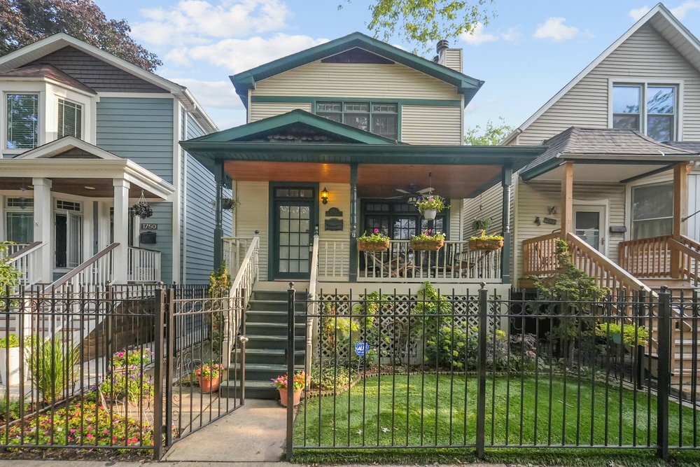 Nestled on a quiet, picturesque, tree-lined street in the heart of Ravenswood, this classic-style home seamlessly blends timeless character with contemporary updates. A welcoming, covered front porch offers the perfect spot for morning coffee, remote work, or evening gatherings. Step inside to an expansive open-concept main floor designed for both comfort and entertaining. The sun-filled living and dining area features rich custom hardwood floors, a full-sized gas fireplace framed by a beautifully crafted mantle, and a convenient powder room tucked away for guests. At the rear of the home, the bright and airy kitchen is a true  centerpiece-complete with a generous island, abundant cabinetry, a walk-in pantry, double ovens, and a seamlessly connected family room bathed in natural light, open to a spacious back porch.  Upstairs, hardwood floors continue throughout three well-appointed bedrooms. The primary suite offers incredible light, walk-in closet, and a luxurious ensuite bath featuring a tub, glass-enclosed shower and double vanity. The fully finished lower level offers incredible versatility-ideal as a media room, game space, or home gym-and includes a built-in bar, fourth bedroom, full bathroom, and ample storage. This level also connects to the detached two-car garage via a private interior hallway. This unbeatable location puts you steps from the vibrant Southport Corridor and Lincoln Avenue, with dining, shops, parks, and entertainment just around the corner. Commuters will love the proximity to major thoroughfares like Ashland and Irving Park, as well as easy access to Lake Shore Drive and the expressway. Public transportation is a breeze from this location.