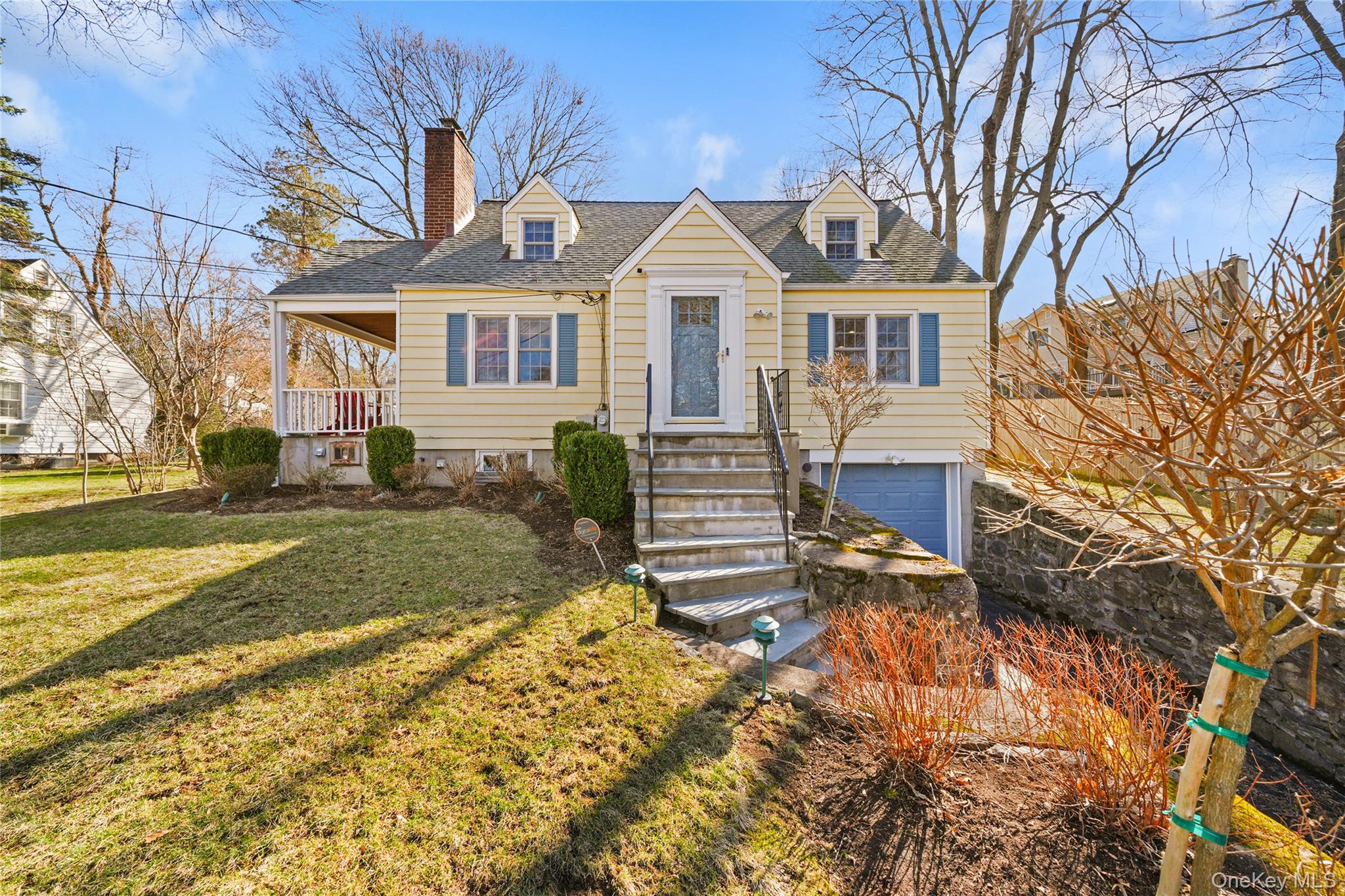 Welcome home to this beautiful 3 bedroom, 2-bath Cape Cod home with exceptional curb appeal, set on a quiet, dead-end street in the sought-after Ardsley School District. The first floor features a primary bedroom and full bath, an inviting eat-in kitchen, and a living room anchored by a charming wood-burning fireplace. Hardwood floors run throughout the main level. Door to covered porch that overlooks the beautifully maintained grounds and the private, level backyard—perfect for play, gardening, or outdoor entertaining. Upstairs, you’ll find two large additional bedrooms, a full updated bathroom and generous storage. The lower level includes a large, finished room ideal for a recreation area, home office, or exercise room, along with laundry, utilities, access to one car garage and abundant storage. Enjoy Greenburgh Recreation privileges and access to Hartsdale Metro-North parking. Conveniently located and close to parks, shopping, exceptional local dining, and major transportation routes for an easy commute to Manhattan. A rare opportunity to own in one of Westchester’s most desirable communities.