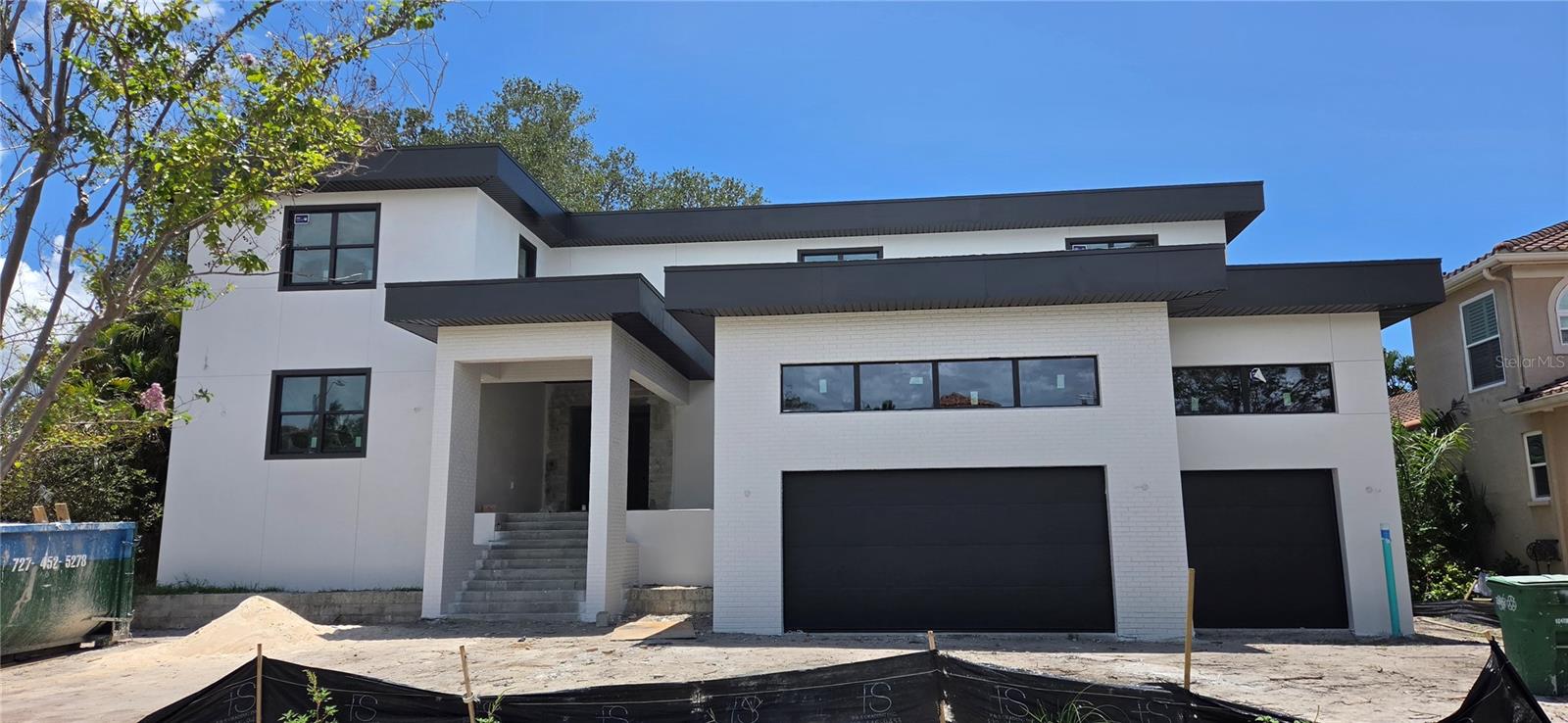 Under contract-accepting backup offers. Under Construction. This masterfully crafted custom home offers 5,331 sf of air-conditioned living space, anchored by a first-floor primary suite and waterfall staircase with glass railing. The layout includes 6 bedrooms and a den. One bedroom could be a flex space suited for a gym, media room, or bonus room. The home offers 6 full baths, a half bath, plus pool bath, with upstairs and downstairs laundry rooms. The first floor is finished out with beautiful, large-format imported Spanish tile. The gourmet kitchen is built around a Viking 48" induction range with brass accents, paired with a full Viking appliance suite including column refrigerator and freezer, convection drawer microwave, and integrated dishwasher. Cabinetry features walnut lowers with glass-front walnut uppers in charcoal accents, a natural walnut refrigerator wall, and a charcoal island topped with premium collection luxury quartz. Haute Frank Lloyd Wright fixtures by Brizo in Luxe Gold, a 36" workstation sink, pot filler, and travertine surround complete the space. The great room features a custom walnut built-in with a 52" Modern Flames electric fireplace coupled with the adjacent parlor with a dry bar with a built-in Viking 24" wine column and patina brass chandelier. The primary bathroom retreat offers a walk-in shower with 67" freestanding soaking tub, draped with chevron tile floors, a 21" Frank Lloyd Wright Brizo rainhead, and dual walnut vanities — all finished in polished nickel and teak wood hardware. Every secondary bath carries its own distinct tile and finish story. Outside, on the spacious lanai, a fully equipped outdoor kitchen — Blaze 32" propane grill, outdoor fridge, drop-in sink, and custom 42" vent hood — anchors the entertaining space alongside the beautiful in-ground pool on a large lot, great for entertaining family and friends! Located on beautiful Davis Islands, enjoy walkability and golf-cart access to village shops and dining, waterfront parks, bike paths, tennis courts, dog parks, marina, beach, and the historic public pool—just minutes to Downtown Tampa, Water Street, Sparkman Wharf, Tampa General Hospital, and the Riverwalk, with convenient access to Tampa International Airport.