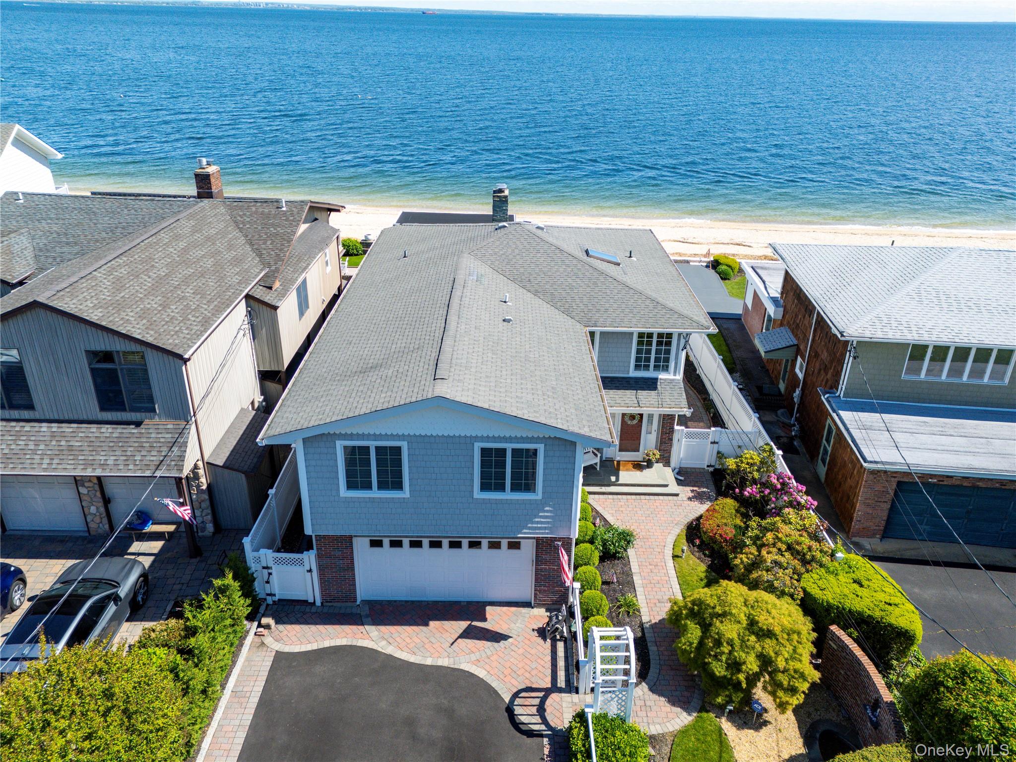 Well maintained waterfront home directly on Long Island Sound. Private maintained beach with views to Connecticut. Home features 3 or 4 large bedrooms with 3 full baths upstairs with separate laundry room. Oversized Master with private deck, walk-in closet, and marble master bath. Kitchen & dining on first floor with sunken living room & gas fireplace, all with water views. Oversized Brazilian Hardwood deck & paver patio with steps to beach. Roll-up awning & Anderson patio doors for entertaining. Home features include 3 zones of both heat & A/C, on demand tankless hot water heater. Full home 22K Generac generator, Central Vac, Custom closets. Beautiful outdoor space with paver walkways & tranquil pond. Quiet dead-end block with only 17 homes. Association dues $700 annually maintains private road & beach.