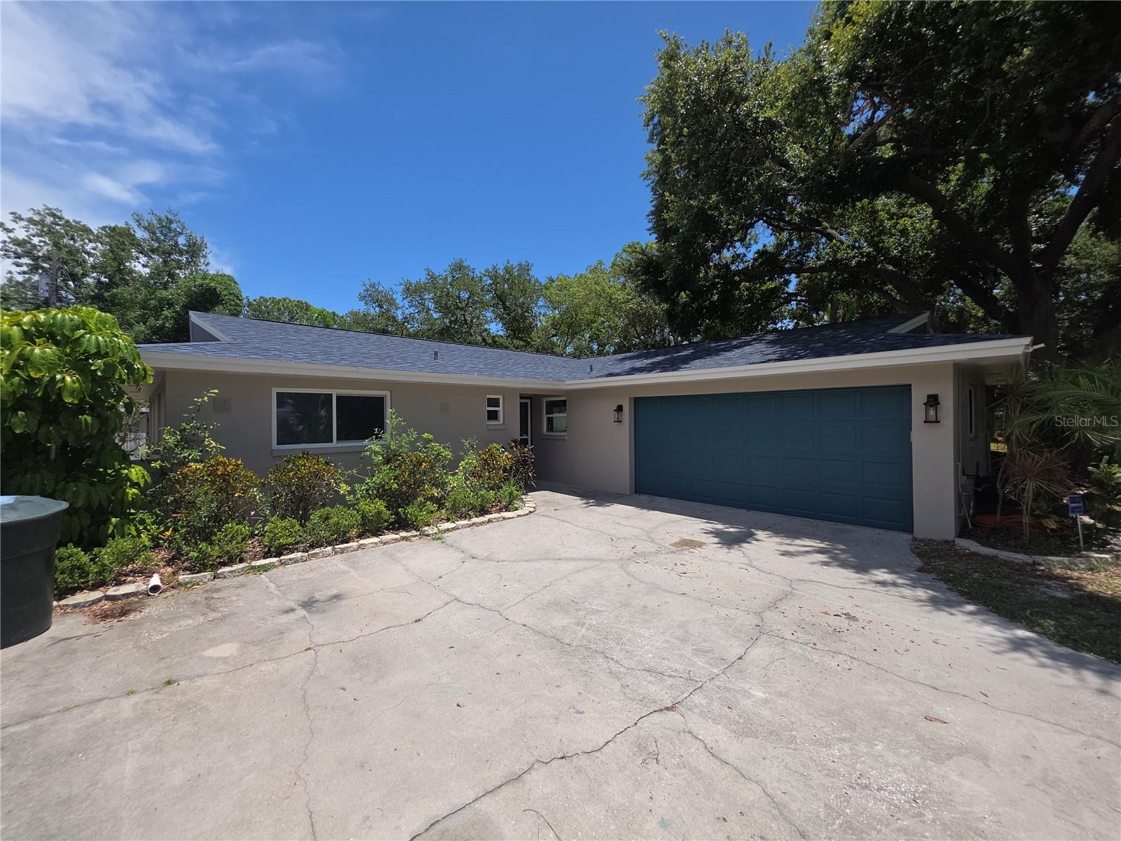 REMODELED GEM DONE WITH A MODERN TAKE ON THE MID CENTURY THEME LOCATED IN THE HEART OF HISTORIC BAYSIDE TOWN OF DUNEDIN. THE PROPERTY FEATURES A NEW COBALT BLUE 3 DIMENSIONAL SHINGLE. IT WAS FRESHLY PAINTED INSIDE AND OUT. THERE ARE 4 BEDROOMS AND 3 BATHS. THE OVERSIZED MASTER SUITE INCLUDES A SKYLIGHT, WALK IN CLOSETS AND A LARGE THERAPEUTIC SHOWER WITH RAIN CAPS AND HAND SHOWER WANDS. THERE IS A SEPARATE SOAKING TUB TO WASH YOUR WORRIES AWAY. THE WALLS ARE ADORNED WITH GEORGIA BLUE GLOSSY TILE FOR A COASTAL FEEL.THE KITCHEN HAS A NEW SHAKER CABINETS AND TONS OF COASTAL GRAY GRANITE. THERE IS A COOKING ISLE AND BREAKFAST BAR. UPGRADED STAINLESS KITCHENAIDE APPLIANCES WILL MAKE THE CHEF IN YOU FEEL ECSTATIC. ALL NEW LIGHTS, MAXIM CEILING FANS AND PLUMBING FIXTURES. ALL BTHROOMS FEATURE NEW VANITIES, TIOLETS, SHOWER GLASS AND NEW TILE WALLS.THE HOME HAS A NEW INSTAHOT WATER SYSTEM, WITH 2 BRAND NEW RUDD AC SYSTEM YOU WILL STAY COOL AND SAVE MONEY.   LOW MAINTAINENCE EVERGLADES NEUTRAL GRAY LAMINATE FLOORS MAKE CLEANING AND DECORATING EASY. THIS PROPERTY FEATURES AN OAK GRACED  HALF ACRE LOT WITH PLENTY OF ROOM FOR RV OR BOAT STORAGE. IT IS ALSO ON A DEAD END STREET, SO NO PASS BY TRAFFIC.THE BACKYARD IS A TROPICAL OASIS WITH A HUGE POOL, COVERED PATIO AND LOTS OF TRAVELERS PALMS, BIRDS OF PARADISE, HIBISCUS AND OTHER EXOTIC PLANTS. YOU CAN JUMP ON YOUR BIKE AND CRUISE DOWN THE PINELLAS TRAIL TO THE HISTORIC MAIN STREET AND ENJOY SHOPPING, GREAT RESTAURANTS AND ENTERTAINMENT. A SHORT CAR RIDE TO HONEYMOON ISLAND AND YOU WILL BE ON ONE OF FLORIDA BEST BEACHES. COME ENJOY SMALL TOWN COASTAL SALT LIFE BOATING, FISHING, JET SKIING. ONLY 10 MINUTES TO DOWNTOWN CLEARWATER BUT YOU WILL FEEL WORLDS AWAY. WALKING DISTANCE TO DUNEDIN ELEMENTARY AND MIDDLE SCHOOLS.