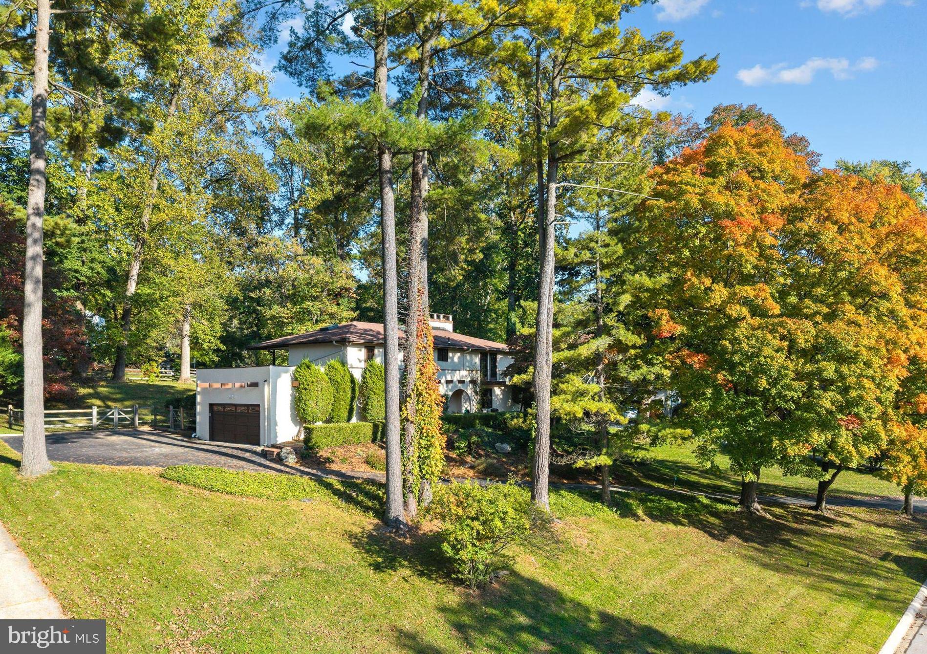 Welcome to 203 Wedgewood Cir, a beautifully updated 5-bedroom, 2.5-bath Spanish-style Colonial offering 3,017 square feet of living space on a quiet street in a prime Newtown Square location. Combining timeless architectural character with luxurious updates, this distinctive home features hardwood floors throughout, three fireplaces, spacious living and entertaining areas, a newly finished lower level, and a private backyard with inviting covered outdoor living spaces.  The main level offers a wonderful blend of formal and casual gathering spaces, beginning with an elegant living room anchored by a charming fireplace. This gracious space provides a warm and inviting setting for intimate gatherings, quiet evenings, or entertaining guests, while offering a more traditional retreat separate from the home's casual living areas. The dining room provides the perfect backdrop for holiday celebrations and memorable dinner parties. The beautifully updated eat-in kitchen is thoughtfully updated with stainless steel appliances, an induction cooktop, double ovens, a 100 bottle wine refrigerator, center island, and generous space for casual breakfast room dining with sliding glass doors inviting you to the back patio and manicured grounds. An inviting family room with a classic brick-surround fireplace creates a warm and welcoming atmosphere, while the adjacent sunroom with walls of glass provides a peaceful retreat overlooking the private patio & backyard. A convenient newly finished first-floor laundry room and mudroom as well as powder room adds functionality to the thoughtfully designed floor plan. The attached 2 car garage features a Tesla EV Charger and plenty of storage space. Upstairs, the beautifully updated primary suite offers a private balcony, spacious custom outfitted walk-in closet and a luxurious newly renovated bathroom featuring heated floors, a heated towel bar, dual vanities, a classic clawfoot soaking tub, and a separate shower with dual showerheads. An adjacent large bedroom with a fireplace and balcony could be a fabulous home office/den or 5th Bedroom. Three additional bedrooms, provide comfortable accommodations and flexible space for guests with ample closet space. The beautifully renovated hall bathroom features a double-sink vanity, and timeless tile surround with a soaking tub/shower combination.  The expansive newly finished lower level provides exceptional additional living space, perfect for a recreation room, home theater, fitness area, or playroom. Outdoors, the private backyard offers a peaceful setting for relaxation and entertaining, complete with a beautiful paver patio and covered patio ideal for alfresco dining and outdoor gatherings.  Ideally situated in sought-after Newtown Square, this home enjoys a convenient location within the Marple Newtown School District and close proximity to several prestigious private schools. Enjoy easy access to the shopping and dining destinations of Newtown Square, including Ellis Preserve, as well as nearby Wayne, Media, and the Main Line. Major commuter routes provide convenient connections to King of Prussia, Center City Philadelphia, and Philadelphia International Airport.  With its distinctive Spanish Colonial architecture, 3,017 square feet of living space, three fireplaces, updated kitchen and bathrooms, newly finished basement, hardwood floors, and private outdoor entertaining areas, 203 Wedgewood Drive offers an exceptional opportunity to enjoy classic charm and modern comfort in one of Delaware County's most desirable locations.