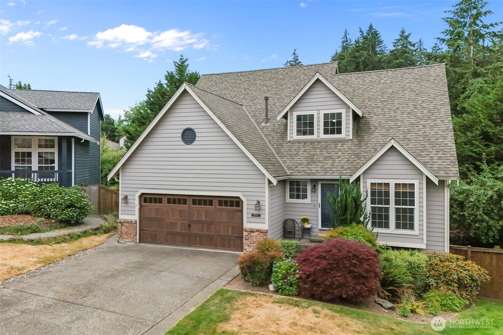 Located in the sought-after Regency Woods neighborhood, this beautifully positioned home sits on a quiet cul-de-sac. The spacious living room offers soaring vaulted ceilings, a cozy gas fireplace, expansive windows, and peaceful greenbelt views. The chef's kitchen features granite countertops, a gas range set in an oversized island, a pantry, and views of the backyard. The primary suite boasts vaulted ceilings, two walk-in closets, scenic views, and a 5-piece bath. The lower level includes an additional living area with a gas fireplace and new carpet, offering excellent potential for multi-generational living or guests. Enjoy outdoor living on the multi-level deck overlooking sweeping territorial views of the greenbelt, complete with a fire pit area, hot tub, large storage shed, and more. Walking trails are just steps away, and the neighborhood park is only a one-minute walk from your front door. Close to shopping and public transportation.