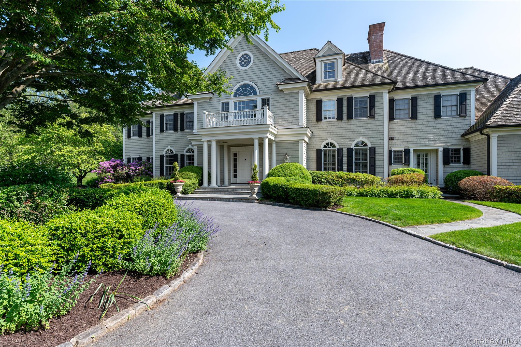 The pinnacle of Modern Colonial elegance in Pound Ridge: timelessclassicism elevated to a grand scale, featuring spacious rooms, prestigeamenities and luxury finishes crafted for contemporary comfort. Set on 3.7acres on exclusive Great Hill Farms Road, it’s minutes from both BedfordVillage and Stamford and an hour to Manhattan. Sunlight streams through the double-height entry, illuminating marblefloors, custom paneling, and striking contemporary chandelier. The formalliving room with wood-burning fireplace, exquisite millwork and Frenchdoors to a terrace opens to a sunroom wrapped in windows. A large dining room also offers French doors to the private patio.  The chef’skitchen dazzles with dramatic lighting, custom banquette and top-tier Wolfrange and Thermador refrigerator which is open to the family room with a beautiful stone fireplace. Upstairs, the luxurious primary suiteboasts twin sets of French doors leading to a balcony, two spa-qualitybaths, and dual custom dressing rooms. Two additional ensuite bedrooms and two other bedrooms that share a bath complete the upper level. The lower level offers everything for full-on recreation: a glass-enclosed gym, cinema room, family room, guest suite, wine cellar and full bar. Outside is a resort style escape offering spectacular landscaping, inviting pool and charming pool house and bocce court offering relaxation and recreation. This Pound Ridge paradise, with easy access to the Merritt and684, is a rare fusion of heritage home and private luxury resort.