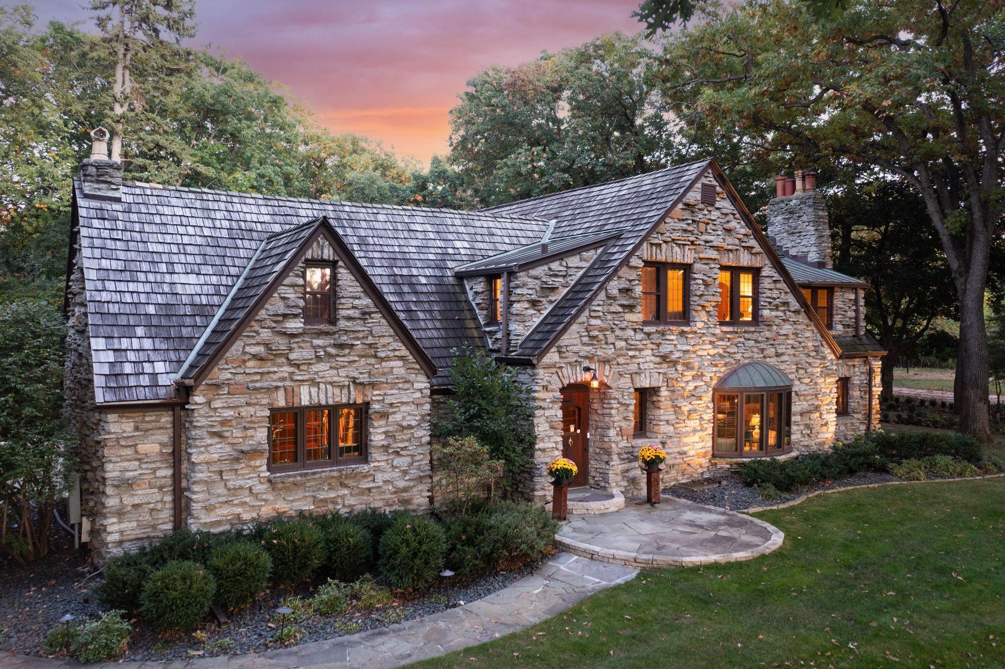 Magical.  No word better describes the joy and charm of this unrivaled 2.36 acre estate which includes not only the handsome stone original Schaefer estate, but also the whimsical 2-story guest house (the original horse stable), which together share the playful rolling terrain, water features, putting green, numerous terraces & outdoor fireplace.  Reimagined as an enchanting entertainment center, the guest house with a total of 3,186 finished square feet includes generous bar and relaxation areas, 2 wonderful guest rooms with private baths, and south facing terrace with retractable awning, while the main home includes 4 spacious bedrooms, kitchen open to main level family room, expansive screened porch, and wainscoted living/dining room with leaded windows.  Total sq. footage and bedrooms/baths in MLS include guest house. A truly rare opportunity.