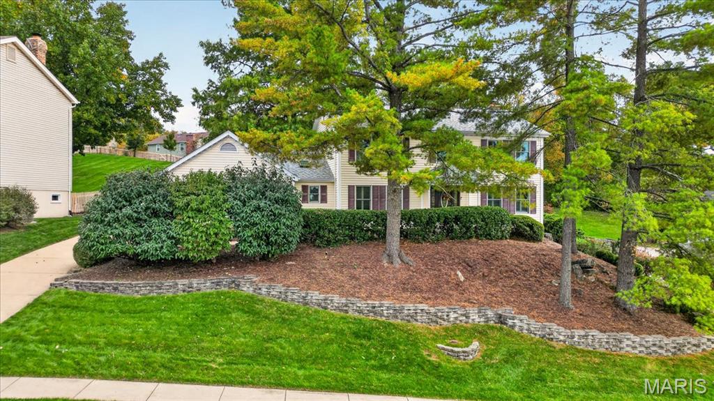 Welcome to your new "chateau". Classic charm meets modern convenience in this beautiful four-bedroom residence. The main level welcomes you with gleaming hardwood floors and a versatile living room that serves perfectly as a quiet home office. The inviting great room features cozy built-ins and a fireplace. The bay window offers a picturesque view of the beautifully landscaped fenced backyard-a private oasis complete with an irrigation system. This space flows effortlessly into the sprawling sunroom, where walls of windows invite in the light and offer a panoramic view of the lush greenery and paver patio. At the heart of the home is the spacious kitchen equipped with granite countertops, a center island, gas stove and double oven for effortless entertaining. The first-floor utility is a bright airy space featuring a skylight and custom built-ins that make organization a breeze.  Retreat upstairs to find four generously sized bedrooms. In the primary suite you will find a walk-in closet with custom built -ins for easy organization. The primary bath has granite countertops and double sinks, each with its own built-in mirrored medicine cabinet. The expansive lower level offers a versatile layout that adapts to your lifestyle. A generous finished area - perfect spot for a media area or secondary gathering spot. It also offers a separate finished room , an ideal set up for a home office or workout space. This level also includes a convenient half bath and a large unfinished storage area.  Rear entry garage. Over 4000 square feet in Parkway Schools.  Don't miss seeing this beautiful home!