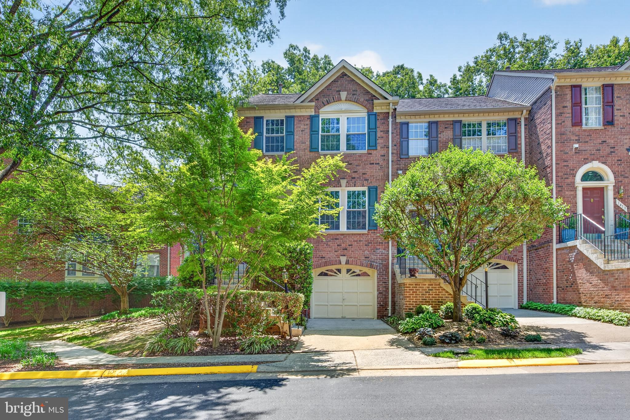 Located in desirable North Reston, this all-brick end-unit townhome offers a private setting backing to trees, along with access to Reston’s incredible amenities, including pools, tennis courts, trails, parks, and playgrounds. With a one-car garage, abundant guest parking nearby, and convenient access to shopping, dining, Reston Town Center, Metro access, and major commuting routes, the location is exceptional.A charming wraparound front porch welcomes you into the home. Inside, the foyer features a convenient coat closet and opens to the spacious main level featuring luxury vinyl plank flooring throughout. The main level offers multiple living and gathering spaces, including a living room, dining room, family room, and breakfast area, along with a convenient powder room. The kitchen is equipped with granite countertops, a pantry, and opens to the breakfast room and family room. Just off the main level, the deck overlooks a peaceful, treed setting, providing a wonderful outdoor space to relax or dine outdoors.Upstairs, all three bedrooms feature vaulted ceilings, adding to the open and airy feel. The spacious primary suite includes a large walk-in closet and an ensuite bath with tile flooring, a soaking tub, a separate shower, dual sinks, and updated faucets and light fixtures.The lower level offers additional flexible living space with a recreation room, full bath, laundry room, and direct access to the one-car garage.Enjoy the combination of privacy, functional living space, and an unbeatable North Reston location close to everything Reston has to offer.