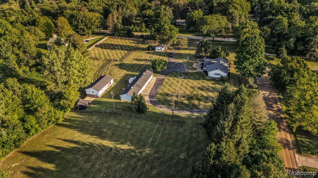 WOW! This one-of-a-kind property has it all—starting with a fully finished 8-car garage featuring 400 amp power, heat, A/C, painted interior, and even its own bathroom with sink and hot water tank. Perfect for car lovers, hobbyists, or anyone who needs serious workspace. Set on 6.7 private acres with an electric gate entrance, the property also includes a massive 2-story pole barn with a basement and 2 horse stalls, plus fenced areas ready for horses or other uses. Whether you’re into equestrian living, storage, or hobbies, this barn delivers space and flexibility. Inside the main home, everything has been completely redone—brand-new bathrooms, lighting, paint, and water heater. The 3-bedroom, 2.5-bath layout features a spacious living room with a gas-log fireplace and a modern granite kitchen. An in-law suite with 1 bedroom and full kitchen makes the perfect guest retreat. With two generators powering both the home and the garage, you’ll always be prepared. This property blends modern updates with wide-open land and unmatched amenities. A rare must-see opportunity on 6.7 acres—don’t wait on this one!