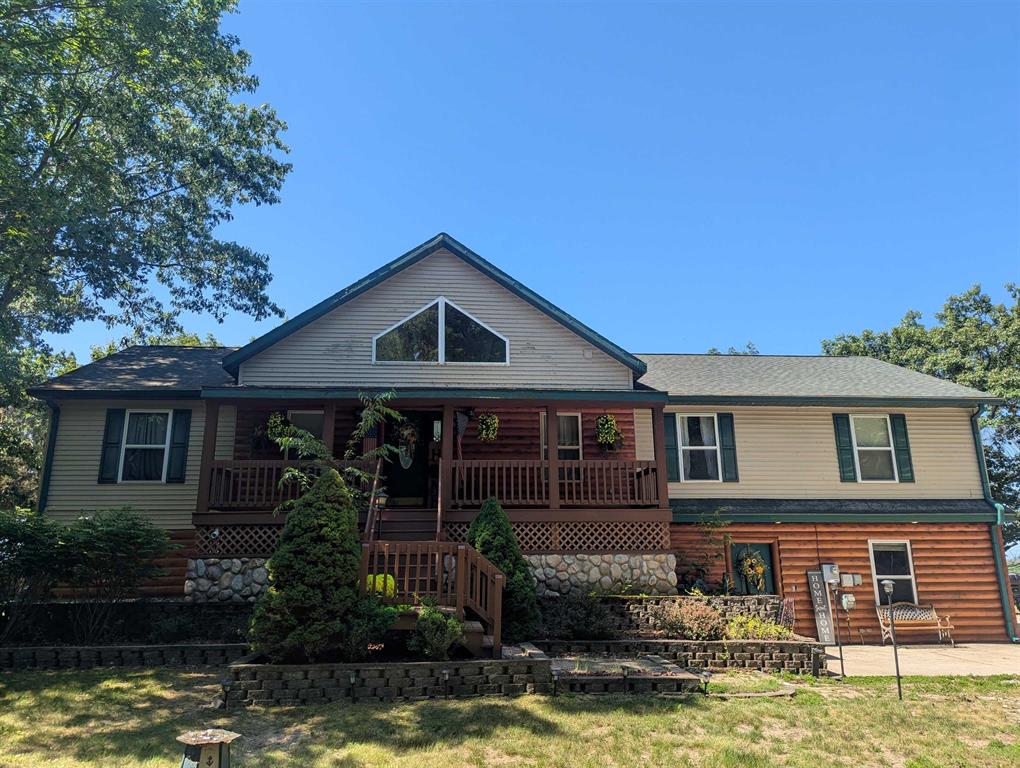A beautiful bi-level home with 112' of frontage along Lake Huron in a gorgeous wooded setting! The elevated main level offers a spacious floor plan with a large living room area with stunning wood ceilings, wood floors, gas fireplace, and a fantastic view of the Lake with door walls that lead out to a large deck just primed for outside enjoyment and entertaining! Also on that level is the primary bedroom with private bath and walk-in closet, three additional bedrooms, two additional bathrooms, & an open kitchen/dining area w/ lots of cabinet space and laundry area. The lower level has a family room, door wall leading out to an enclosed sun room, possible fifth bedroom, and another bathroom. Recent updates include all of the bathrooms, exterior, and the deck! For storage, there's a mud room and 2 car attached garage! Located not far from the City of Au Gres, US-23, multiple marinas, golf courses, etc!!