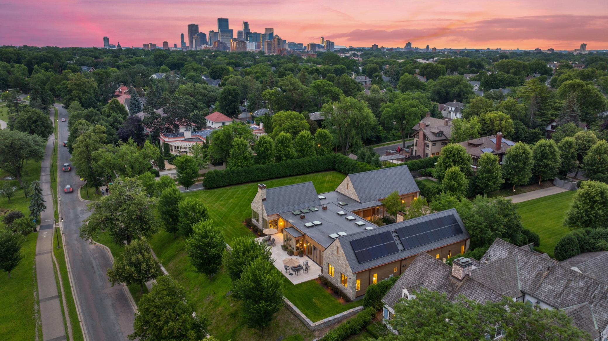 Unprecedented lakeside living on Lake of the Isles. A rare opportunity to own one of Minneapolis’ most iconic modern residences, perfectly positioned on the most coveted homesite on Lake of the Isles. This architectural masterpiece pairs timeless elegance with contemporary design, offering sweeping lake views, soaring glass walls, and abundant natural light throughout. A thoughtfully designed multi-pavilion layout delivers effortless single-level living, with seamless flow between formal entertaining spaces, relaxed family areas, and private bedroom suites. Outdoor living reaches new heights with an elevated lakeside terrace and a secluded courtyard featuring a fireplace, fountains, dining area with phantom screens, and full grilling station—ideal for year-round entertaining. This home was built with sustainability in mind, including a solar array and Tesla Powerwalls that significantly reduce environmental impact. Additional amenities include a sport court, exercise room, and a spacious attached, heated three car garage. Set behind the gated and manicured entrance off Lake Place, this expansive lakeside property offers unmatched privacy in one of the city’s most prestigious settings, creating a truly unparalleled urban retreat.