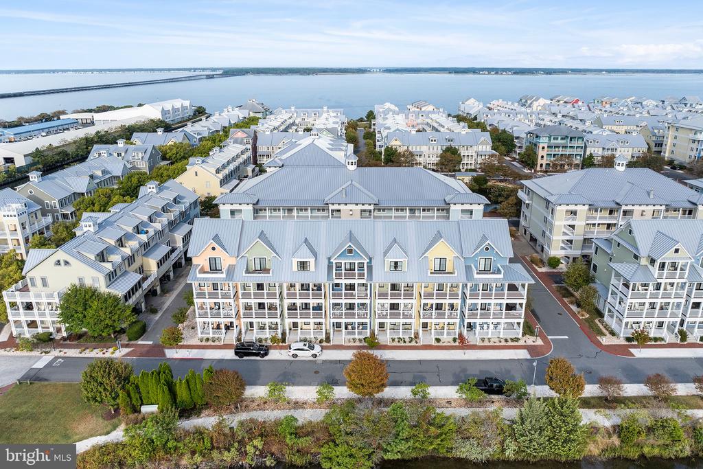 Custom-Built Luxury in Sunset IslandCrafted by one of the Mid-Atlantic’s premier builders, this rare townhome represents the very best in quality and design. What sets these homes apart? Unmatched attention to detail, uncompromising use of premium materials, and induvial customization. With only 20 custom Main Street townhomes in Sunset Island, opportunities like this are few and far between.The floorplan was over two years in the making, carefully designed to maximize views and enhance the charming streetscape. At more than 3000 square feet, this residence answers the market’s call for space, comfort, and style. Every bedroom is a true suite, complete with its own full bath. The primary retreat boasts its own oasis, a private deck perfect for sunrises and breezy afternoons, and a spacious layout that feels like a getaway of its own. A den or 5th bedroom on the entry level, paired with an adjacent full bath, adds versatility for guests or a home office.Soaring ceilings—9 feet on the first three levels and 10 feet on the top floor—create an airy, open feel throughout. Fit and finish are simply impeccable: 4- and 6-inch decorator trim, oak staircases, white quartz countertops in the kitchen and all six bathrooms, and a timeless beach-cottage aesthetic that’s both warm and sophisticated.This home comes fully furnished and accessorized, ready for you to move in and make it your own. It’s practically brand new, meticulously cared for, and in pristine condition. Outside, a rear two-car garage offers plenty of room for your beach gear, while the private driveway expands parking capacity to accommodate up to four vehicles.Homes of this caliber don’t linger on the market. Don’t miss your chance to own one of Sunset Island’s finest custom townhomes—schedule your showing today.