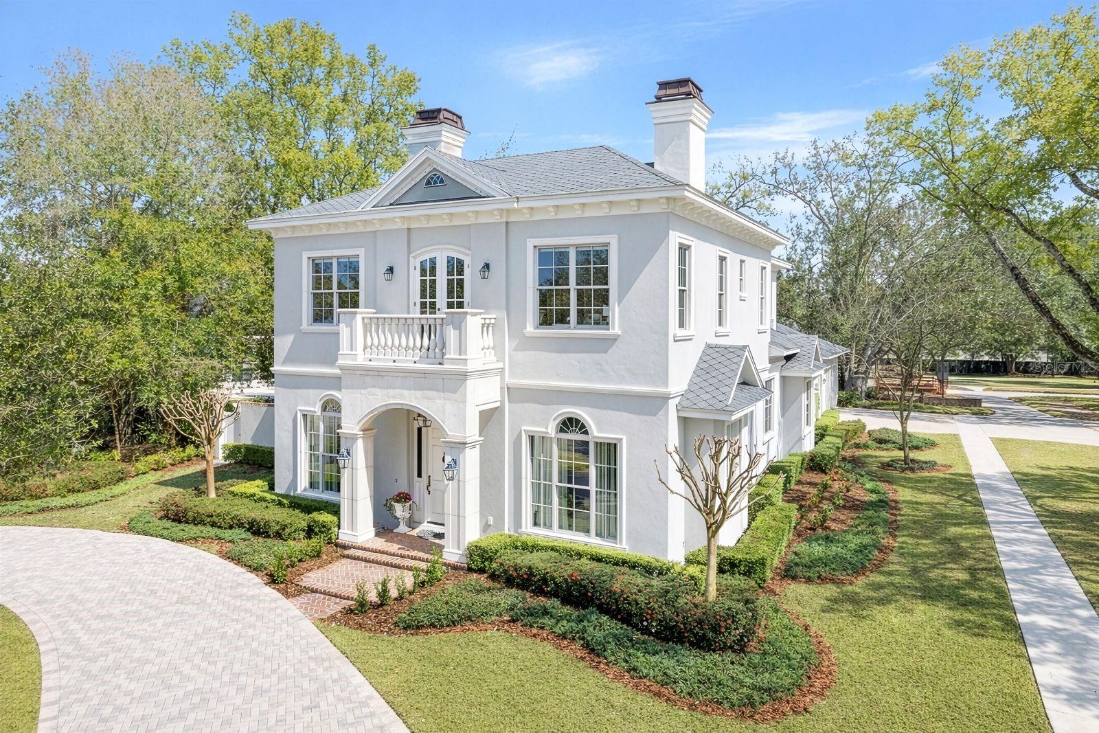 Set along a picturesque brick street, 2040 Randall Circle is a beautifully crafted residence that pairs timeless architecture with elevated, designer finishes and a functional floor plan. Framed by manicured landscaping and connected to a detached two-car garage by a covered walkway, the home offers classic curb appeal in an idyllic setting just minutes from vibrant shopping and dining on Park Avenue. Inside, rich hardwood floors run throughout the living spaces, complemented by Restoration Hardware lighting that brings a refined, cohesive feel to every room. The welcoming foyer opens to a gracious formal living room with a gas fireplace and custom built-ins, an elegant yet comfortable space for entertaining or relaxing. Just beyond, the formal dining room is well proportioned for hosting holiday gatherings and dinner parties with ease. The heart of the home is the expansive chef’s kitchen, thoughtfully designed for everyday living and effortless entertaining. An oversized island anchors the space, topped with Carrara marble counters and offering generous seating. A dual Wolf oven with six-burner range plus French cooktop, custom cabinetry, walk-in pantry, and a butler’s pantry complete with under-counter wine refrigerator provide beauty and functionality. A spacious breakfast room filled with natural light overlooks the backyard and flows seamlessly into the family room. Here, a gas fireplace, custom built-ins and three sets of French doors create a warm focal point while inviting in the outdoors. The first-floor primary suite serves as a private retreat, featuring large windows with tranquil views of the pool and direct access to the covered lanai. Dual walk-in closets provide ample storage, and the spa-like primary bath is finished in Carrara marble, offering a large soaking tub and an expansive glass-enclosed shower with dual shower heads. Two powder baths, one thoughtfully designed as a pool bath, along with one of two laundry rooms complete the main level. Upstairs, four additional bedrooms and a dedicated office provide generous space for family and guests. Two of the bedrooms feature private en-suite baths, while the remaining two share a well-appointed Jack & Jill bath. One of these rooms is arranged as a bonus lounge, offering flexibility to serve as a fifth bedroom, media room or additional gathering space if desired. The thoughtful second-floor layout easily adapts to a variety of lifestyle needs, whether accommodating guests, growing families or multi-generational living. A secondary laundry room upstairs adds an added layer of everyday convenience. Outdoor living is equally impressive. The spacious covered lanai with summer kitchen overlooks the saltwater, heated pool and spa, creating an extension of the interior living space. Brick paver flooring continues from the lanai to the open patio, offering multiple areas for lounging, dining and entertaining beneath the Florida sky. Ideally in a desirable location and zoned for sought-after Audubon Park K-8, 2040 Randall Circle offers timeless style, thoughtful design and seamless indoor-outdoor living in one of the area’s charming neighborhoods.