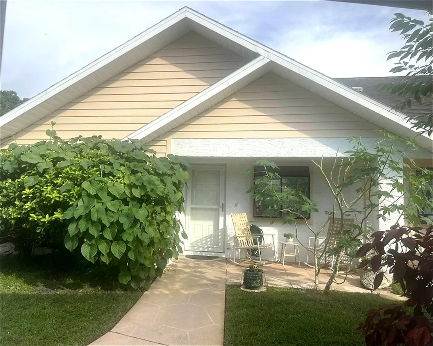 Charming, lovely, newly renovated 2BR/2BA home/villa in Tall Pines Community with beautiful front and back patios overlooking an absolutely magical pond view via the back patio and looking through from inside the home! New kitchen with special large plant window and brand-new stainless LG appliances, updated bathrooms—the primary bath has a beautifully tiled walk-in shower, and the hall/main bath has a large bathtub and updated vanity. Both bedrooms are spacious and have large walk-in closets in this special home. The primary bedroom is 11x14, the primary bath is 5x11, the secondary bedroom is 10x12, and the hall/main bath is 5x8. Fabulous open and classic layout where the secondary bedroom and the hall/main bath areas can be sectioned off via a pocket door for privacy.Luxury vinyl flooring throughout, custom window coverings, new ceiling fans, updated lighting, and professional/curated paint throughout. Alarm system. Beautiful sunlit lighting with front and back patio areas. Tons of space for plants and patio furniture indoors and outdoors. The back patio has a very large outdoor area and a large enclosed lanai/Florida room, also with custom window coverings and new flooring—it looks out onto such a beautiful pond, offering the most peaceful atmosphere with such natural beauty and opportunities for wildlife viewing! The sun sparkles on the water throughout the day, in the morning time, and when there’s fog just above the water—it’s sincerely one of the most spectacular views ever! Truly a million-dollar view, right in your backyard and visible throughout your home!The front porch has a beautiful seating area with ample space where presently a table and modern rocking chairs are situated, along with vibrant plants, greenery, and large original viburnum hedges, which span the perimeter of the home. Open, bright interior layout can be made very cozy when all the custom blinds are closed. This home/villa is an end unit and is one of the biggest and original lots available in the Valley Wood community, with surrounding windows and very special views/rarely available. Covered carport with 2 parking spaces. Attached and fully enclosed large lanai/Florida room—this is also where the laundry cove/closet and water heater are accessed behind 2 large bi-fold doors.Close to everything! There is a fantastic new pub/restaurant and swim school right next to the clubhouse, inside of the community—less than a 5-minute walk door to door! Publix and other great shops, parks, golf courses, and even more restaurants are barely a 2-minute drive away! Starkey Wilderness Park and playground area are minutes away. The hiking, biking, equestrian, and birding trails are remarkable! Suncoast Parkway is right around the corner. 30-minute drive to Tampa and the Tampa International Airport! 10-minute drive to the new Medical Center known as Speros FL.This home is for sale by owner and sold AS IS. This home/villa is part of a quiet, well-maintained community where the HOA covers the roofing, exterior painting, lawn maintenance, trash, sprinkler systems, street lighting, and roads. Enjoy access to the clubhouse and all the community activities. This home has it all!