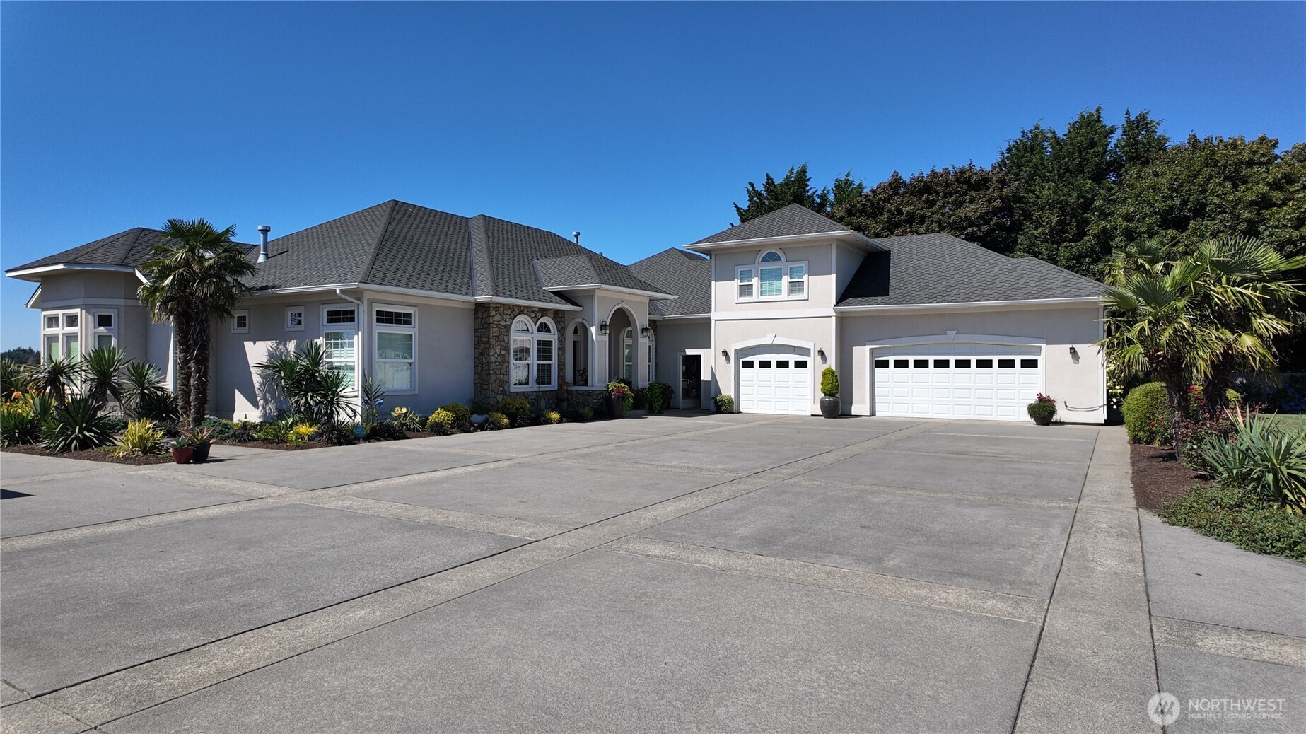 Custom-built home on 8+ scenic acres in Mount Vernon’s Skagit Flats. Designed for accessibility and luxury, all main living areas are located on the ground floor, including a massive primary suite, executive office and junior ensuite suite. The kitchen features premium appliances, granite countertops, double ovens and butler's pantry. Exterior amenities cater to horse and garden enthusiasts with a barn, pasture, greenhouse, and orchard. The property further includes a 3-bedroom ADU and extensive garage space, including a finished detached garage with plumbing.
