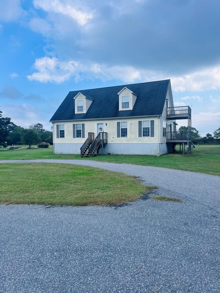 Charming, Waterfront, Cape Cod close to NASA, Wallops Island & Chincoteague.  Nestled along the Seaside in Bloxom, the Hopeland Way Subdivision offers expansive, panoramic views of Kegotank Bay, it's Barrier Islands, and, just past that, the Atlantic Ocean. Sit on the porch or decks, and experience a gorgeous sunrise over the ocean, or take in one of the next scheduled NASA/Wallops rocket launches - both right in your backyard! Community Pier/Dock for small boating, kayaking, paddle-boarding, and other watersports.  New Roof 2021, New HVAC unit 2024. Endless possibilities with this property, from a great weekend getaway spot to full-time residence, call now to book your showing today!