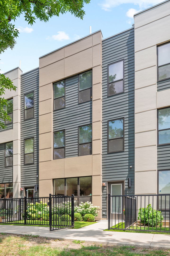 STUNNING URBAN STYLE TOWNHOUSE IN AVONDALE WITH THREE LEVELS OF LIVING, PRIVATE ROOFDECK, PRIVATE BACKYARD, AND TWO CAR GARAGE. THIS NEWER CONSTRUCTION UNIT (2020 BUILD) IS HIGHLY UPGRADED AND MOVE-IN READY. LOCATED ON A QUIET TREE LINED ONE-WAY STREET FEATURING GATED FRONT ACCESS TO A PRIVATE ENTRANCE. FIRST FL FEATURES KITCHEN WITH MODERN FLAT PANEL WHITE CABINETRY WITH ROLL-OUT DRAWERS AND BUILT-IN FEATURES, QUARTZ COUNTERS, BOSCH SS APPLIANCES, ISLAND WITH BREAKFAST BAR, BEVERAGE REFRIGERATOR AND BACKSPLASH. CUSTOM WALK-IN PANTRY AND OPEN CONCEPT LIVING AND DINING ROOMS WITH CUSTOM BUILT-IN SHELVING. FIRST FL POWDER ROOM, AND REAR ENTRY "MUDROOM" BUILT-INS. THE SECOND FLOOR FEATURES TWO SECONDARY BEDROOMS WITH CUSTOM WALK-IN CLOSETS, FULL BATH WITH DUAL SINK VANITY AND UPGRADED SHOWER TILE SURROUND, LAUNDRY ROOM WITH CUSTOM CABINETRY AND TILE, AND UTILITY ROOM WITH ADDITIONAL STORAGE. THIRD LEVEL LARGE PRIMARY SUITE WITH CUSTOM WALK-IN CLOSET, LARGE BATH WITH DUAL SINK VANITY, WALK-IN SHOWER AND SEPARATE WATER CLOSET. THIRD LEVEL ALSO FEATURES A VERSATILE LOUNGE/DEN/OFFICE SPACE WITH CUSTOM BUILT-IN BOOKCASES WITH LED LIGHTING. INTERIOR STAIRS TO PRIVATE ROOFDECK WITH SKYLINE VIEWS. NOTABLE UPGRADES INCLUDE WIDEPLANK HARDWOOD FLOORING THROUGHOUT, SOLID CORE INTERIOR DOORS, RECESSED LIGHTING, INTEGRATED SONOS SPEAKER SYSTEM AND DIMMER SWITCHES, ALL INTERIOR WINDOW TREATMENTS, REVERSE OSMOSIS SYSTEM IN KITCHEN, NEW KOHLER TOILETS, FRESHLY REFINISHED ROOFDECK, FRONT AND BACKYARD LANDSCAPING WITH TURF, PAVER TILED PATIO, LANDSCAPE WATERING SYSTEM TO ROOF AND BACKYARD, ALL CUSTOM INTERIOR LIGHTING, GARAGE STORAGE SHELVING, AND EV CHARGING SYSTEM. CONVENIENT LOCATION NEAR BLUE LINE, METRA, I-90 INTERSTATE ACCESS, AND CLOSE TO TRENDY DINING AND ENTERTAINMENT OPTIONS IN AVONDALE AND LOGAN SQUARE.