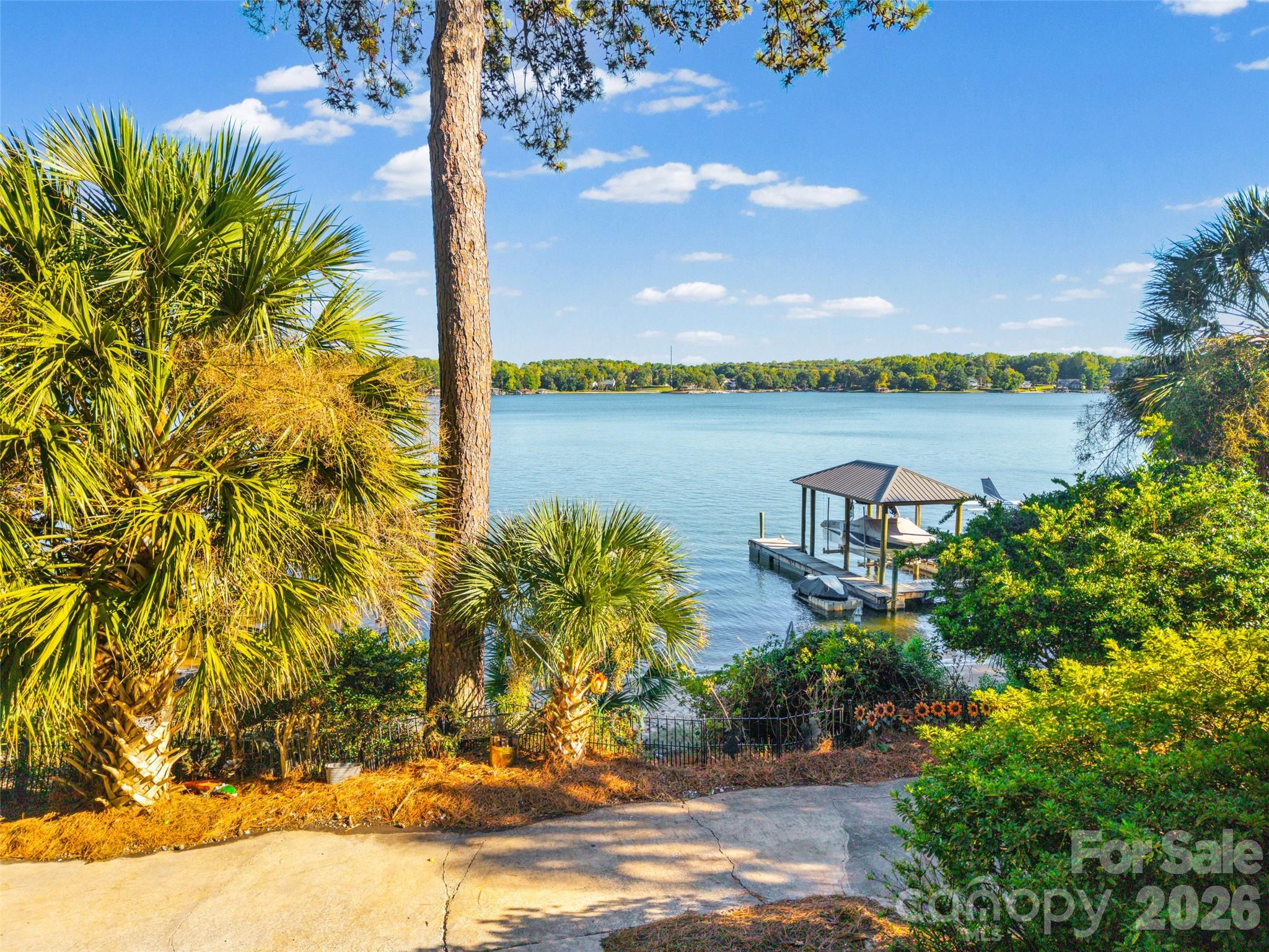 Rare Waterfront Opportunity in Coveted Tega Cay – Main Channel Views, Sandy Beach & Brand-New Dock!It’s all about the lake life! Welcome to a truly special waterfront property in highly desirable Tega Cay, where breathtaking main channel views of Lake Wylie, a rare flat sandy beach, and a brand-new dock completed in August 2026 create the ultimate lakeside retreat!The real story here is the waterfront lifestyle. Imagine stepping right out your back door onto your own sandy beach, spending sun-filled afternoons on the water, or relaxing on your screened porch while soaking in the spectacular lake views. The expansive main channel views are simply stunning, and the rare sandy beach with easy access to the water is a feature that truly sets this property apart. Whether you’re boating, swimming, entertaining, or simply enjoying a peaceful evening by the lake, this is the kind of setting where unforgettable memories are made.Lovingly cared for by the same family for the past 25 years, this home has been the backdrop for countless cherished memories, and now it’s ready for its next chapter! The sellers have taken great pride in maintaining the property while making thoughtful improvements along the way. Recent updates include many replacement windows (2024), updated bedroom and bathroom doors, replacement HVAC and water heater, and a beautifully updated downstairs bathroom featuring new tile and shower (2025). Additional enhancements include crown molding throughout, removal of popcorn ceilings, and kitchen updates featuring quartz countertops, tile backsplash, and newer stove, dishwasher, and refrigerator. Solid surface flooring extends throughout most of the home, with the exception of just two rooms. The foundation was also reinforced in 2022 by DryPro and includes a warranty.While the home offers numerous updates and has been carefully maintained, there’s still an opportunity for its next owners to bring their own vision and personal touches to make it truly their own.Properties with this combination of main channel views, a flat sandy beach, and a brand-new dock are a rare find! The setting is exceptional, the possibilities are endless, and the lifestyle is what dreams are made of.After 25 wonderful years, one family is ready to pass along this special piece of Lake Wylie paradise to its next owners. Now it’s your turn to make a lifetime of memories on the lake!