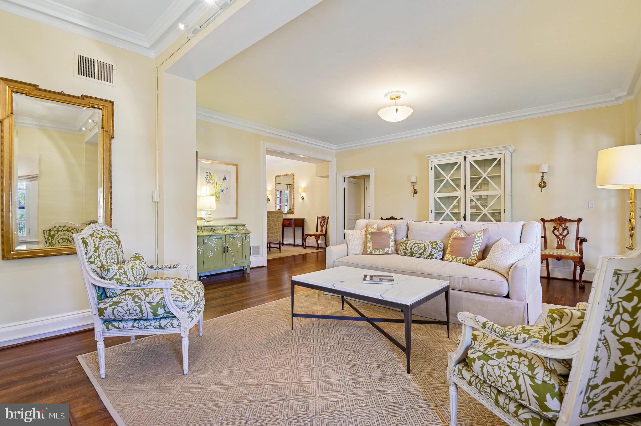 You will think you're living in a small Mediterranean village, where every corner of this charming property invites you to bask in its beauty and history. Constructed in 1922 by the talented architect Clyde N. Friz, this exquisite development showcases a captivating blend of Mediterranean and Italian Renaissance styles that truly feels like a walk back in time. This spacious first-floor unit offers a luxurious living experience, complete with all the comforts you desire. As you enter, you are greeted by a warm and welcoming entrance hall that sets the tone for what lies ahead. To your right, a grand living room awaits, adorned with a beautifully crafted fireplace flanked by built-in bookshelves—perfect for housing your favorite reads or displaying treasured decor. French doors lead you seamlessly to an unparalleled covered veranda, where you can savor your morning coffee, take afternoon naps, or indulge in al fresco dining. This property boasts two generous primary bedrooms, each featuring its own en-suite bathroom, ensuring privacy for everyone. A cozy family room with stylish built-in cabinetry offers a warm space for relaxation, while a private office with custom-designed storage includes a clever concealed doorway that provides convenient access to one of the bedrooms.For those who love to entertain, the formal dining room easily accommodates 18 seated guests, with overflow space accessible through French doors that lead out to a charming rear deck and a secluded hidden yard, complete with a stunning stacked granite stone retaining wall—a serene backdrop for gatherings or quiet reflection.Culinary enthusiasts will appreciate the expansive kitchen, designed for both functionality and style, with an abundance of counter space, custom cabinetry, stainless steel appliances, a range hood, and the convenience of an included washer and dryer. The back door leads to a lower-level storage room, ensuring that everything has its place.And to top it all off, a deeded garage is included with the sale, adding further convenience to this already exceptional property.Don’t miss your chance to own a slice of paradise in this storybook setting!