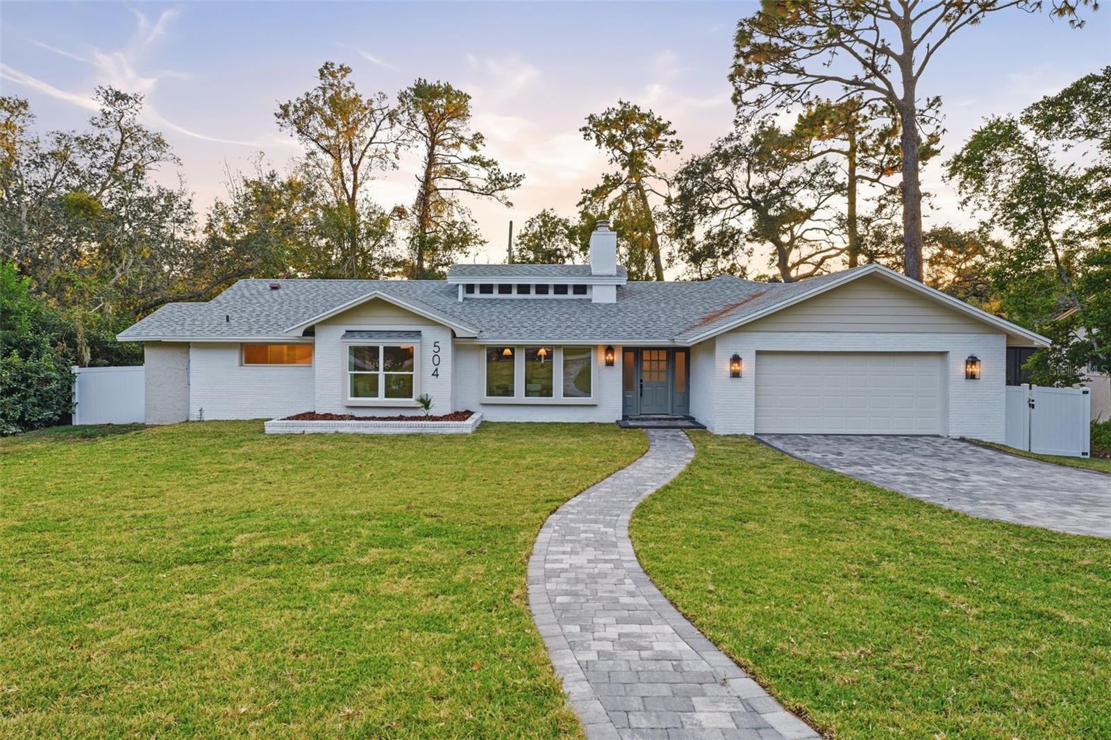 Under contract-accepting backup offers. Welcome to the experience of high-end living at 504 Smokerise Blvd—a fully reimagined masterpiece in Sweetwater Oaks, Longwood’s premier lakeside community. Recently completed by a professional interior designer to be their own showcase home, this 2,611 sqft four-bedroom plus office, three-bath split-plan residence presents the absolute finest in modern Florida style. Welcoming you with soaring 14’ custom ceilings and abundant natural light from over 30 new energy-efficient windows/skylights you are welcome to enjoy the elegant open-concept spaces in a home that radiates architectural sophistication. Entertain or unwind with two modern fireplaces, a formal dining or flexible family room, and a stunning D'Nook-designed gourmet kitchen fitted with soft-close cabinetry, premium appliances, dedicated custom nook area and a statement Venetian plastered hood. The oversized center island with designer lighting provides an inspiring hub for both casual meals and large gatherings. Every detail speaks to luxury—from quartz countertops and exclusive stone front sink, to custom brick and wood finishes and contemporary designer touches throughout. Retreat to your expansive owner’s suite complete with spa-inspired bath, freestanding soaking tub, walk-in closet, and private pool balcony—your haven for daily relaxation. Enjoy flexible living with three additional bedrooms and a dedicated office. Step outside to nearly three-quarters of an acre of nature views, your fully renovated pool with new equipment, charming pavers, and a bathroom accessible to pool guests. Recent updates include a new roof, windows, skylights, vinyl and aluminum fences, sprinkler system, and fresh landscaping, and major systems all completed in 2025 for peace of mind. As part of Sweetwater Oaks, indulge in private Lake Brantley access for boating, tennis, pickleball, volleyball, basketball, two playground parks, an exclusive beach, clubhouse, and top-rated Seminole County schools. Just 20 minutes to downtown Orlando, 40 minutes to Disney and the beaches. This is not just a home—it is our finest Sweetwater Oaks designer remodel to date. Schedule your tour and discover luxurious living, unmatched craftsmanship, and the Florida lifestyle you deserve.