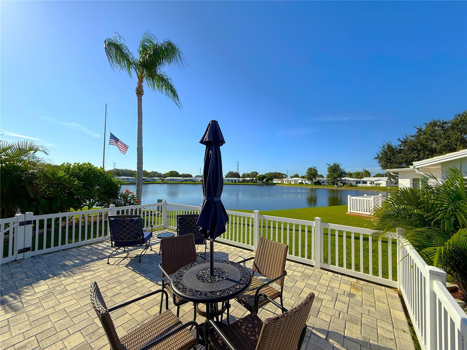 Location, Location, Location! This stunning move in ready waterfront corner lot has it all! The kitchen has been thoughtfully updated, featuring Plenty of storage space, elegant Quartz countertops, sleek stainless-steel appliances, under-cabinet lighting, a custom tiled backsplash, recessed lighting, and a reverse osmosis water filtration system, all while offering picturesque views of the lake! High-impact windows throughout the home are adorned with custom plantation shutters, enhancing both aesthetics and functionality. The interior boasts some newer paint, adding a fresh touch. The versatile third bedroom can serve multiple purposes, functioning as a home office, gym, or craft room, depending on your needs. Outside, the spacious covered lanai is surrounded by lush tropical landscaping, creating a serene atmosphere. A charming brick-paved walkway leads to the rear of the property, where an oversized brick-paved patio awaits, perfect for enjoying breathtaking Florida sunsets, enhanced by mature landscaping that provides privacy and expansive water views. Nestled in a vibrant, amenity-rich community, you'll enjoy easy access to Mainlands Sparkling Community Heated Pool and Clubhouse, Mainlands Golf Course, Freedom Lake Park that offers: Dog Park with large, fenced exercise space separated for large and small dogs, hydrants, watering holes, and plenty of shade for your pets, covered outside fitness stations, fishing, grilling, picnic tables, pavilions, new playground, walking track and the Korean War Memorial. This home's ideal location puts you close to all the best that the area has to offer - from world-class Gulf Beaches, Sam’s Club, Coffee Shops, Fitness Centers, shopping, dining, Helen Howarth Park, Equestrian Trail, Dog Park, and Forbes recreation area, I-275, St. Pete/Clearwater and Tampa International Airports. Whether you're an adventure-seeker or simply seeking a peaceful oasis, this home offers the perfect setting to elevate your Florida lifestyle.