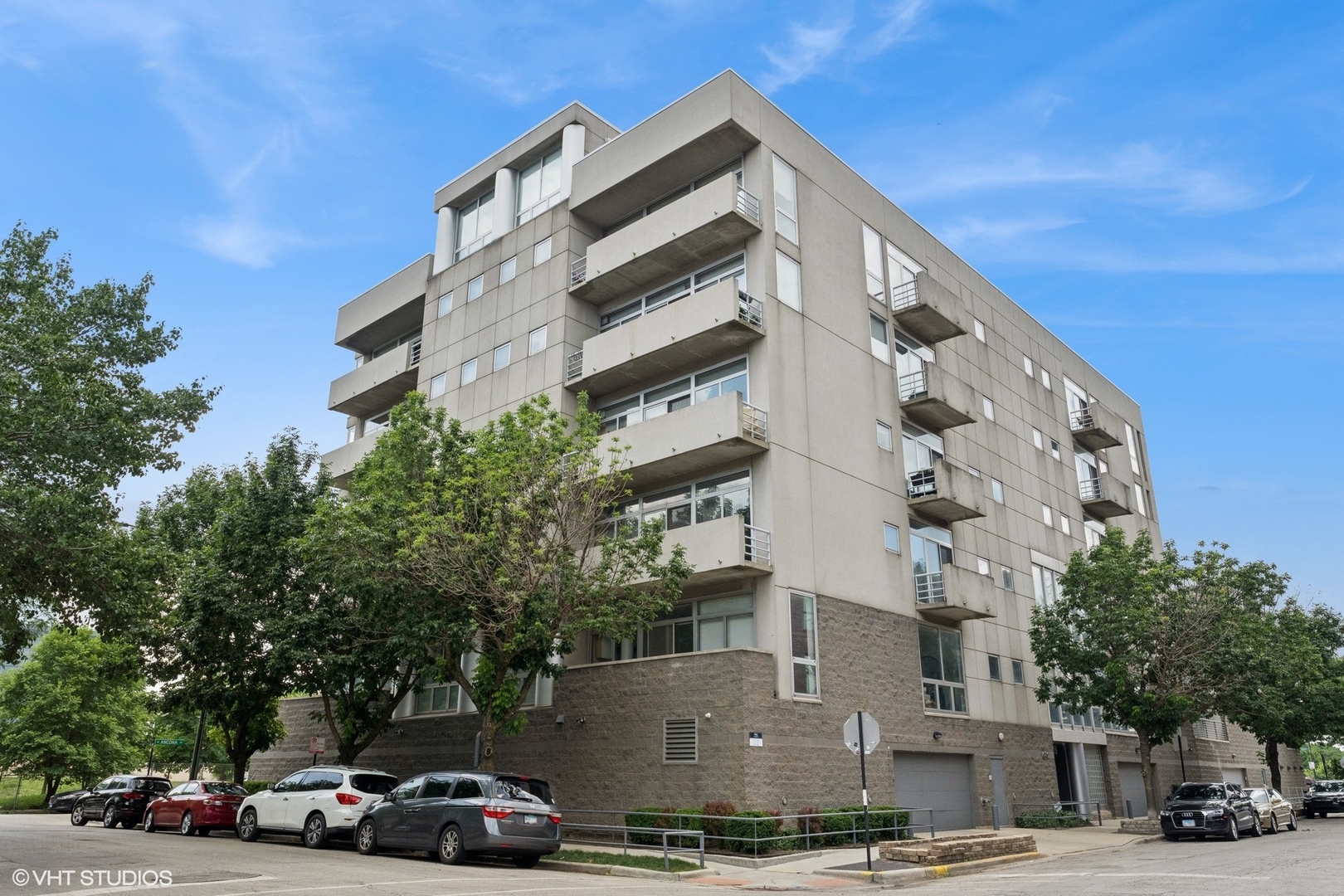 Welcome to over 2,100 square feet of bright, contemporary living in the heart of River West. This oversized 2 bed, 2 bath corner condo offers panoramic south and east views, floor-to-ceiling windows, and two private outdoor spaces perfect for soaking up the skyline. The spacious 22-foot living room features a gas fireplace with a custom surround and flows into a formal dining area and a gourmet kitchen complete with a 12-foot breakfast bar, granite countertops, premium stainless steel appliances, and endless 42" maple cabinetry. The split layout ensures privacy, with two large bedrooms-including a massive primary suite with an enormous walk-in closet and a spa-like bathroom with double vanity and jetted tub. Additional perks include in-unit laundry room with full-size washer and dryer (2024), updated furnace (2023), water heater (2024), and thoughtfully built-out closets. The building features secure entry, package receiving, security systems, elevator access, a common roof deck, and heated garage parking included. Located just one block from the Chicago Blue Line and minutes from Bucktown, Wicker Park, and Randolph Street's best restaurants, shops, and nightlife-this pet-friendly home is a rare blend of space, style, and unbeatable convenience.