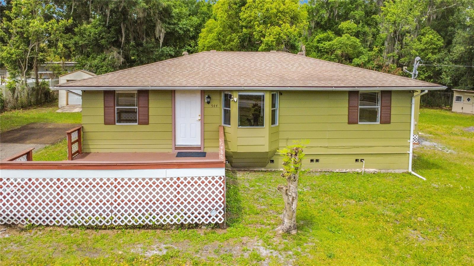One or more photo(s) has been virtually staged. Welcome to a rare opportunity in East Orlando! This charming 3-bedroom, 1-bath home located at 544 Mercury Avenue offers the freedom so many buyers are searching for — NO HOA and NO restrictions. Bring your toys, your boats, your RVs, and yes… even your chickens!Situated on an oversized 0.40-acre lot just outside of Avalon Park and minutes from shopping, dining, and the new development near Starbucks, this property offers the perfect combination of convenience, space, and privacy. Inside, you will find a cozy and functional layout with a formal living room and dining room, a remodeled kitchen featuring new cabinets and newer appliances (2025), and luxury vinyl flooring throughout. The updated bathroom includes a relaxing jacuzzi tub along with handicap-accessible grab bars.The home also features a mudroom/laundry area with a new window A/C unit, along with two versatile outdoor work or play spaces. One shed is in great condition and includes a newer lawn tractor, while the second shed is ready for removal, giving you the opportunity to customize the space to your needs. Major improvements provide peace of mind, including a roof installed in 2018, fence from 2016, newer well pump motor, new water softener system (2025), septic cleaned in 2025, and subflooring and floor joists replaced in May 2025 with a 30-year warranty. Enjoy outdoor living with a new wood deck and a newly paved asphalt driveway.This is a cozy home ready for a new family, offering endless possibilities whether you want to expand, garden, store equipment, or simply enjoy your own private space. All of this while still being zoned for A-rated schools. If you are looking for affordable homeownership with land, flexibility, and no HOA restrictions, this is a must-see.   Don't wait and lose the opportunity that awaits you.