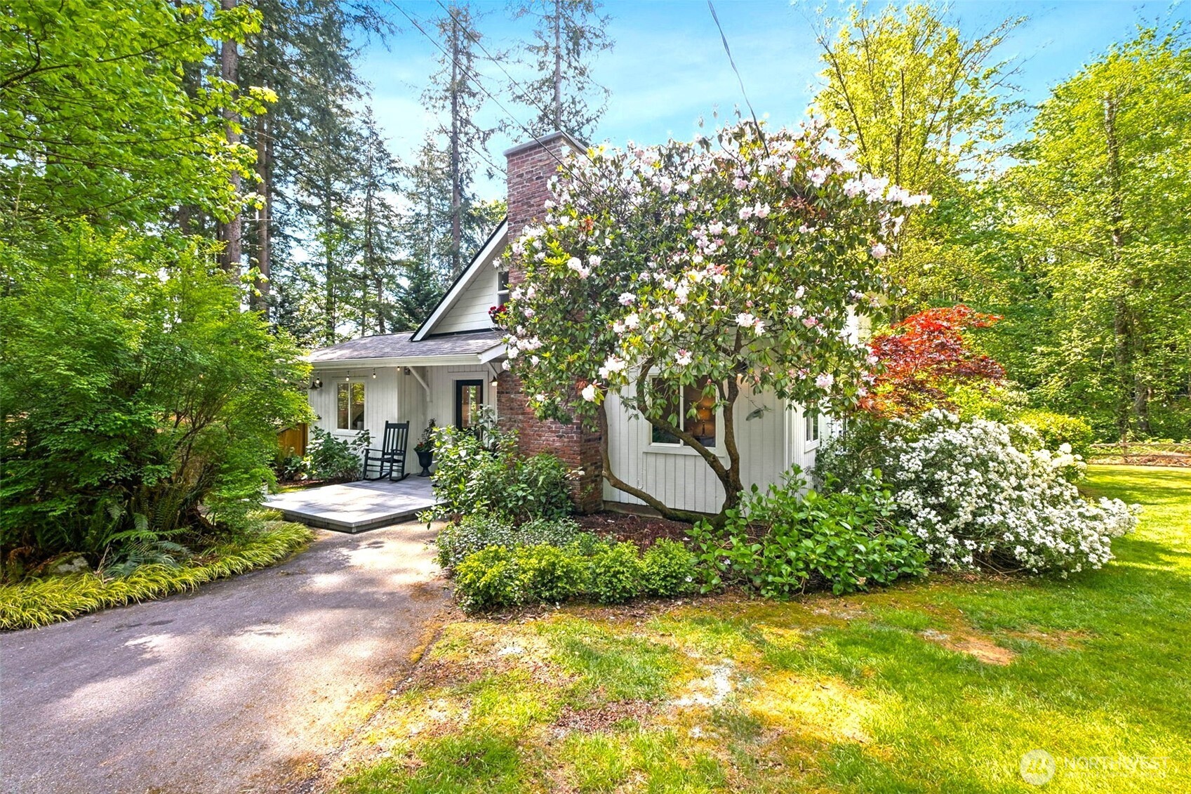 This enchanting cottage-style retreat is a blend of charm, thoughtful updates & lifestyle flexibility on an expansive 1.43-acre property tucked into Tiger Mtn! AND, if you have been wanting to get into the Issaquah Sch Dist., this all-updated home offers an exceptional price & opportunity! From the moment you arrive, the setting draws you in w/an expansive tiled front patio creating an elegant & welcoming first impression—perfect for morning coffee or an evening glass of wine. The home itself exudes timeless cottage appeal, enhanced by years of careful updates. New flooring throughout most of the home, complemented by fresh interior paint that brightens every space. The main level showcases beautiful white-painted open beam ceilings, adding architectural interest & an airy, spacious feel. The remodeled kitchen is both stylish & functional. Custom French-style cabinetry offers a refined, European-inspired aesthetic, while thoughtfully leaving upper wall space open to preserve the natural light streaming through expansive windows. Walk-in pantry doubles as a wine & coffee bar room w/slider door leading to expansive back deck. Main-level primary suite w/remodeled attached bath includes oversized walk-in tiled shower that feels like a private spa, + its own separate deck. Upstairs, you’ll find 3 bdrms, offering flexibility for guests or family w/half bath. Property has a 5-bdrm septic system installed in 2005. Enjoy quick access to outdoor recreation & top rated Issaquah Schools!
