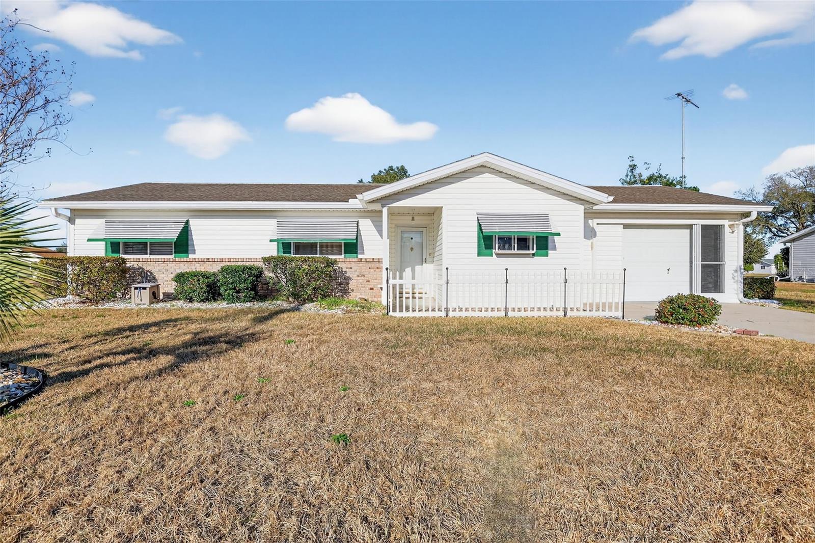 Welcome to resort-style living in Summerfield! This beautifully maintained Cypress model is in the sought-after gated 55+ community of Spruce Creek South and offers comfort, convenience, and an active lifestyle. This inviting residence features 2 bedrooms, 2 bathrooms, and approximately 1134 square feet of thoughtfully designed living space. The open floor plan provides a bright and airy feel, perfect for both relaxing and entertaining. The primary bedroom offers a large walk in closet as well as a spacious bathroom with tile in the walk in shower that also has a glass door.  The guest bath has a spacious layout with a tub and tiled shower combo with lots of storage.  The guest bedroom has a large closet and lots of room for visitors.  The kitchen offers ample cabinetry, generous counter space, and a cozy eat in dining area. The microwave and refrigerator are both new! Enjoy peaceful mornings and relaxing evenings in the Florida room, overlooking the landscaped yard. The Florida room has beautiful tile flooring and windows with blinds as well as a wall unit for additional comfort on those sunny Florida days.  Additional highlights of the home include vinyl floors in the dining room, hall and bedrooms with laminate in the bathrooms, carpet in the living room and tile in the kitchen. There is a large golf cart garage on the back of the home with a garage door that opens to the back yard.  The large garage offers a garage door opener with an outside keypad,  built in kayak racks and a side collapsible screen door.  There is a screen door that leads from the kitchen into the garage as well.  The front door boasts a beautiful glass storm door as well as a skylight in the foyer.  The home also has a TV antenna that gets many local tv stations without paying for cable.Spruce Creek South residents enjoy: 18-hole golf course,  25,000 sq ft Clubhouse and fitness center with hobby/game rooms, library, billiards, social spaces and event rooms. Swimming pool and spa, Tennis and pickleball courts, softball and many other active social clubs. Conveniently located near shopping, dining, medical facilities, and The Villages. Best of all, Spruce Creek doesn't have bonds!Experience easy Florida living in a vibrant, welcoming community. Schedule your private showing today!