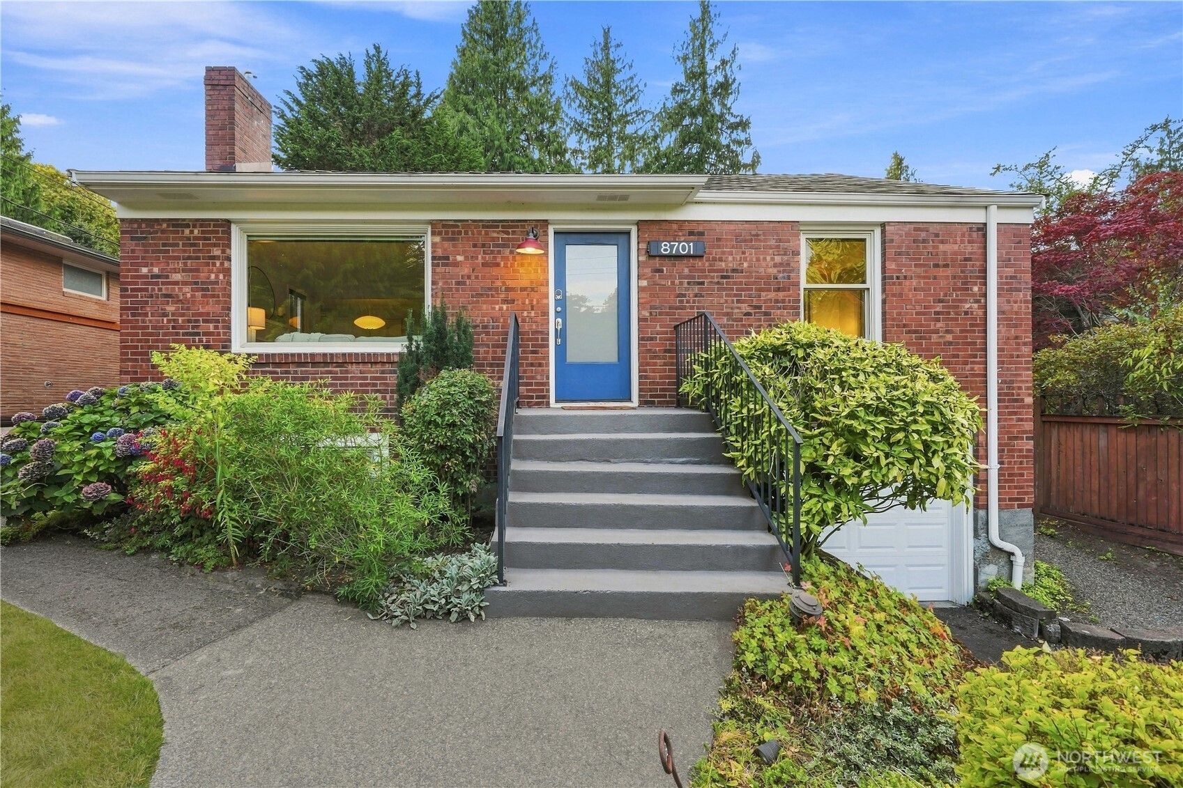 Beautifully situated on a quiet dead-end street, this North Beach home offers the rare combination of city convenience, privacy, and a peaceful greenbelt setting. Golden Gardens and its popular off-leash dog park are just a stroll away, along with neighborhood favorites Larsen’s Bakery, Caffè Fiorè, and Sunny Hill Pizza. The sunny main floor features a welcoming living room with wood-burning fireplace, separate dining room, and kitchen with stainless steel appliances, gas range, and direct access to a covered backyard patio. Two bedrooms and a beautifully remodeled full bathroom complete the main level, while original hardwood floors add warmth and character throughout much of the home. Downstairs offers flexible living space with a spacious family/recreation room, third bedroom, full bathroom, and stackable washer/dryer. The one-car garage includes an outlet ready for an EV charger. Step outside to your private, covered patio and enjoy the tranquility of a backyard bordering a lush greenbelt. Watch for owls, nesting herons, and abundant wildlife while relaxing or entertaining. A raised garden bed is ready for your next planting project, and the Italian plum tree offers a seasonal harvest. A special opportunity to enjoy the best of North Beach! Close to beaches, parks, restaurants, and all that Seattle has to offer, yet tucked away in a wonderfully private and peaceful setting. Seller-procured inspection available!