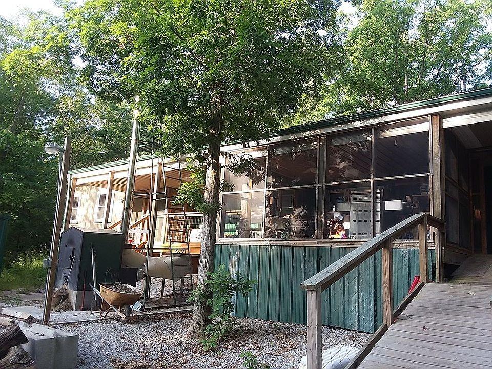 Perfect hobby farm! Preppers paradise! A homesteaders dream! Rustic atmosphere with peaceful country living. Perfect for hunting deer or turkey! There are 2 RV full hook-ups. 1 has an RV carport and 8x10 tornado shelter. The barn offers a 10x24 loft that already has electric, sewer and water. A commercial 30x96 greenhouse, all making this property the perfect place to have at home income! Everything has been built within the last 10 years. all underground utilities. All built with 30 years of construction experience. There is 10 more connecting acres that are for sale too if interested in a larger property. There is a YouTube video viewable by searching the address. Park with 16x16 shelter, 4x8 outhouse, 16x16 outdoor kitchen, 24x50 barn, 30x30 aviary, 16x16 concrete bunker, 16x16 shed with concrete floors. every building has water and electricity.