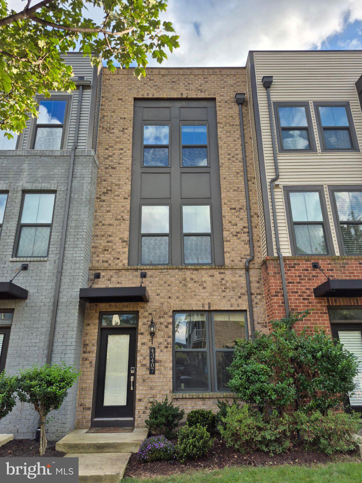 Welcome to this beautifully designed 4 level townhome featuring 3 bedrooms, 3.5 baths, a one-car garage, full driveway, balcony, and a private rooftop terrace. Ideally located just steps from Evermoore Park and moments from the community clubhouse, this home offers exceptional space, modern finishes, and convenient outdoor living.The entry level features a large open recreation room to use for an office, exercise room, or another living space – featuring engineered hardwood flooring, oak stairs, and upgraded balusters throughout the staircases, along with a large storage closet. The main living level showcases an inviting open-concept layout with engineered hardwood flooring, a cozy fireplace, and balcony. The bright kitchen features white cabinetry, granite countertops, a breakfast island, stainless steel appliances, and modern lighting. The refrigerator and dishwasher were replaced in 2026.The third level features engineered hardwood hallway and LVP floors throughout, with 2 large bedrooms, including a spacious primary suite with a beautifully appointed en-suite bath featuring dual quartz vanities and upgraded flooring and shower tile. The second bedroom enjoys its own full bath with upgraded flooring and shower tile.The fourth level offers even more flexible living space, with a third bedroom, full bath, open loft, and access to the rooftop terrace—an ideal setting for relaxing, entertaining, or enjoying the outdoors. Engineered hardwood flooring continues throughout this level, while the bathroom features upgraded flooring and shower tile.Parking is exceptionally convenient with a one car garage, full driveway, abundant parking along the front of the community and parking in the rear - for plenty of family/friends to visit anytime.Enjoy resort-style community amenities, including 3 parks, large open park spaces, 3 playgrounds, an amphitheater, dog park, fitness center, clubhouse, community pool, walking/jogging trails, pavilion, and BBQ grills. Unbeatable location—just minutes to Broadlands Marketplace and Loudoun Station (movie theater, shops, and restaurants), quick access to the Dulles Greenway, and Dulles Airport—making commuting and entertainment incredibly convenient!This spacious 4 level townhome combines versatile living spaces, upgraded finishes, multiple outdoor spaces, and abundant parking in a highly desirable setting.