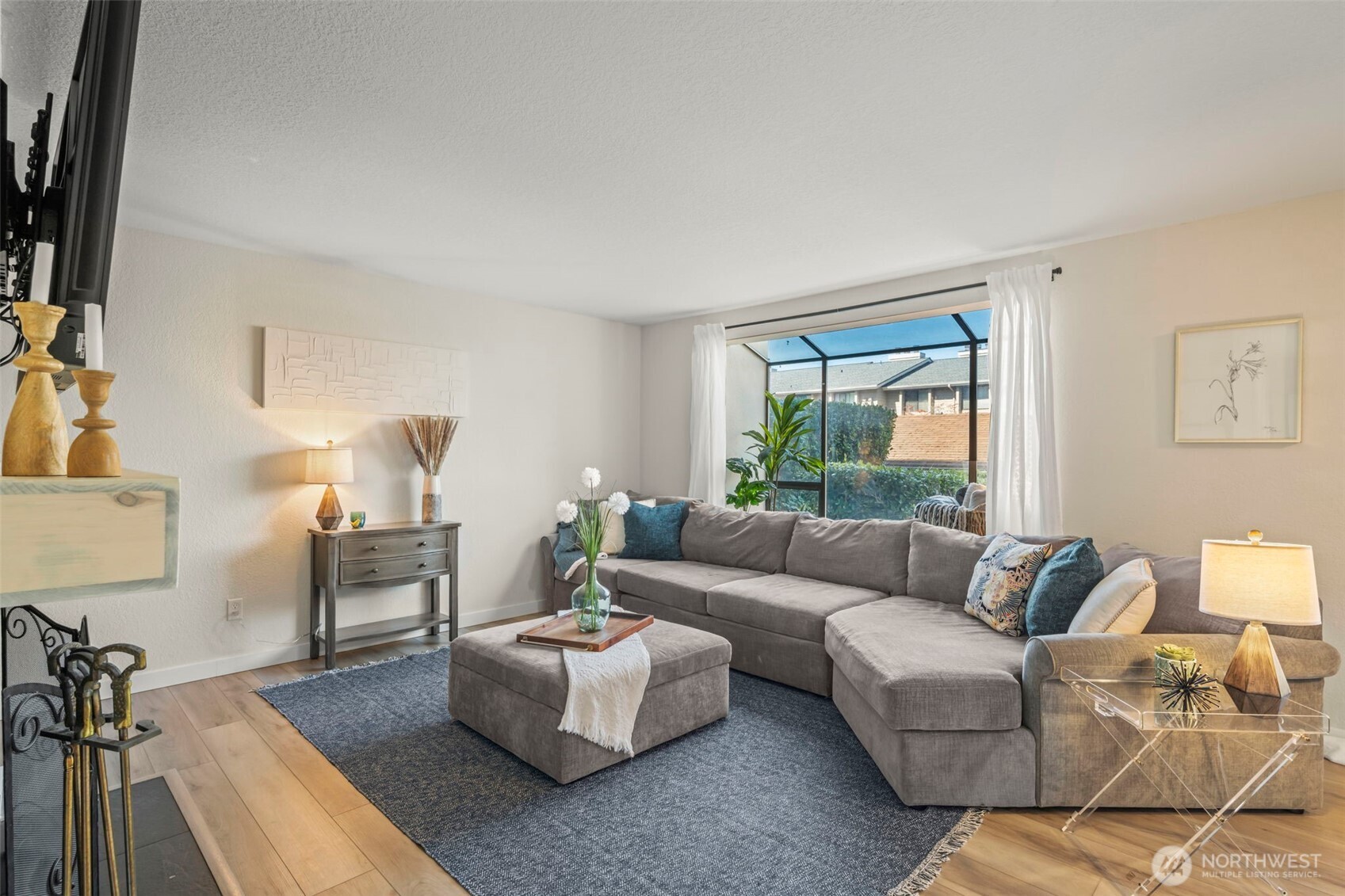 Welcome to this beautifully updated condo in Renton’s desirable Benson Hill area!   Thoughtfully upgraded throughout and move in ready, this inviting home blends modern finishes, comfort, and exceptional functionality.  Inside, LVP flooring flows throughout, complemented by updated lighting and a warm wood-burning fireplace. The kitchen features stainless steel appliances, while the updated bathrooms offer a fresh, contemporary feel. Exceptional storage includes generous closet space, upgraded entry and primary bedroom closet systems, plus a private storage closet on the patio. Enjoy the convenience of in-unit laundry with a full-size washer and dryer. One covered parking and one open parking spaces included.  Step outside to the private patio to enjoy a morning cup of coffee or an evening sunset.  Ideally located near shopping, dining, parks, everyday amenities, and major commuter routes, this thoughtfully updated home offers a stylish, low-maintenance lifestyle in a fantastic Renton location.