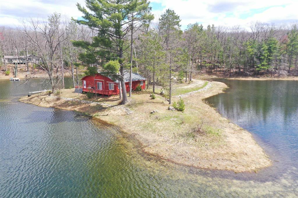 Rare 2.3-acre private lakefront retreat with approx. 1,000 feet of frontage on Muleshoe Lake, directly across from Huron National Forest! Nestled on approximately 2.3 acres with an incredible estimated 1,000 feet of private frontage on Muleshoe Lake, this unique northern Michigan property offers the perfect blend of privacy, recreation, and year-round functionality. Located about 5 miles north of Rose City and just 10 miles south of Mio and the renowned AuSable River, this 3-bedroom, 1.5-bath home features approximately 1,496 square feet of living space with baseboard hot water heat, dedicated laundry and utility rooms, and rustic charm throughout. Positioned directly across M-33 from Huron National Forest, outdoor enthusiasts will appreciate immediate access to thousands of acres of public land plus the ability to ride snowmobiles and ATV/ORVs directly from the property to nearby trail systems. The propertys expansive private lake frontage on Muleshoe Lake offers exceptional privacy, fishing, kayaking, and waterfront enjoyment, with dock included. Two detached garages (18x26 and 24x36) provide outstanding storage for vehicles, boats, and recreational equipment, while the larger garage also includes a partially finished heated room with wood stove-ideal for a workshop, hobby space, or seasonal gathering area. New shingles in 2025 add peace of mind. Whether youre seeking a full-time residence, up-north getaway, hunting/fishing basecamp, or recreational retreat, this versatile property delivers a rare combination of waterfront, acreage, outbuildings, and direct access to some of northern Michigans best outdoor opportunities.