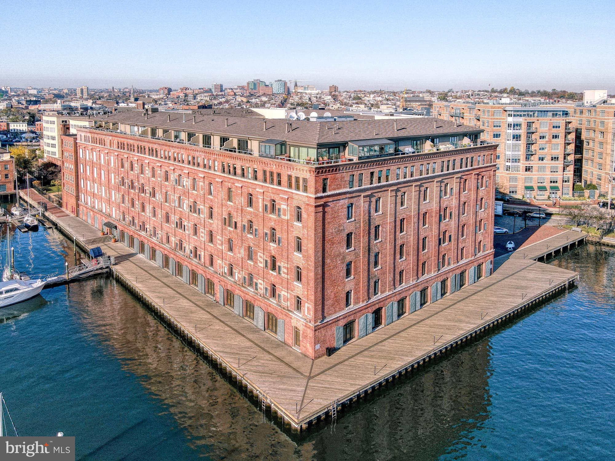 Experience elevated waterfront living with stunning water views in this exceptional 2,768-square-foot, two-level penthouse residence—one of the largest floor plans at Henderson’s Wharf in the heart of historic Fells Point. Perched above the harbor at 1000 Fell Street #612, this light-filled home offers an unparalleled waterfront lifestyle with sweeping vistas of the marina, city skyline, and ever-changing harbor.Expansive windows frame breathtaking views and fill the home with natural light, while the elevated penthouse position provides both privacy and a front-row seat to Baltimore’s vibrant waterfront. From morning coffee as boats glide by to evenings with city lights reflecting across the water, every moment here is defined by the view.The main level welcomes you with raised ceilings, rich hardwood floors, and an open-concept design ideal for both everyday living and entertaining. The beautifully updated kitchen features granite countertops, stainless steel appliances, and a generous layout that flows seamlessly into the expansive living and dining areas—perfectly oriented to capture captivating water views. A stylish half bath adds convenience for guests.Upstairs, the private quarters offer a true retreat. The primary suite is a sanctuary, complete with a sitting room featuring a wood-burning fireplace—perfect for cozy evenings. The suite is complemented by a well-appointed bath and private balconies overlooking the water, creating a peaceful, resort-like setting. A second bedroom offers its own charm with a garden-view balcony, ideal for guests or a serene home office.Located along the coveted waterfront promenade, this residence places you just steps from Fells Point’s cobblestone streets, boutique shops, acclaimed dining, and lively cafés. Enjoy easy access to the Baltimore Harborwalk, perfect for scenic strolls along the water.With its rare penthouse vantage point, expansive layout, and breathtaking views, this is a truly exceptional opportunity to experience waterfront living at its finest.