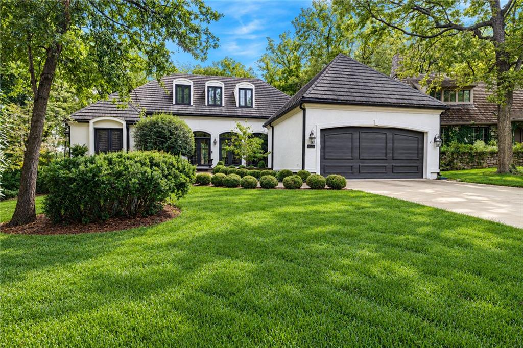 Welcome to this charming villa nestled within the gated community of Loch Lloyd, ideally situated on a quiet, tree-lined cul-de-sac and surrounded by mature trees. With a desirable floor plan, spacious rooms, and plenty of opportunity to personalize, this home is ready for its next owner to make it truly their own. The main level features an open and thoughtfully designed layout with a private office and spacious primary suite. The primary bath offers dual vanities, a freestanding soaking tub, and dual walk-in closets, creating a comfortable and relaxing retreat. The hearth room kitchen features a dramatic floor-to-ceiling stone fireplace and flows easily into the adjoining living spaces. Main Floor offers an office with built ins. The walkout lower level provides exceptional flexibility with a guest suite, family room, a second office, and a third non-conforming bedroom. With generous living space and multiple areas to work, relax, and entertain, there is plenty of room to create spaces that fit your lifestyle. Step outside to the large deck overlooking the  wooded backyard—an ideal setting for morning coffee, outdoor entertaining, or simply enjoying the peaceful surroundings. This is a wonderful opportunity to bring your vision and make this Loch Lloyd villa your own. Enjoy the exceptional lifestyle of Loch Lloyd, a premier gated community offering beautiful surroundings, outstanding amenities, golf, dining, trails, recreation, and a vibrant social atmosphere—all within a private, gated setting.