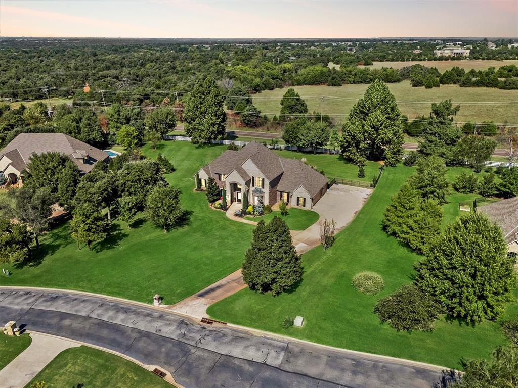 Live the Lifestyle You Deserve. Nestled in the sought-after, gated enclave of Edinborough Pointe in East Edmond, this exceptional residence offers a perfect blend of timeless elegance and everyday comfort.  A spectacular resort style pool redefines outdoor living with a pergola, fire place, outdoor kitchen, and multiple outdoor living spaces. Step inside to discover rich hardwood flooring flowing throughout the main living spaces, bathed in natural light and framed by high ceilings. The expansive living room is a true showstopper, with a corner stone fireplace, and seamless flow into the gourmet kitchen and dining areas—crafted for effortless entertaining. The chef-inspired kitchen is a dream come true, featuring premium stainless steel appliances including double ovens, sleek countertops, and a layout that’s as practical as it is stylish. Unwind in the serene primary suite, with a private entry to the backyard and pool area. The remodeled spa-like ensuite is a sanctuary in itself, boasting a luxurious jetted soaking tub, separate vanities, a massive walk-in shower, amazing closet, and private access to the patio. Upstairs, discover a three additional bedrooms with 2 full bathrooms, and a versatile bonus space perfect for a playroom, home gym, or second living area. Downstairs also includes a dedicated home office and formal dining, ideal for both work and entertaining. Outdoor living is equally impressive, with a spacious covered patio, outdoor fireplace, and a large yard ready for summer gatherings. Storm shelter in the garage.  Well water and Septic system. The Property also includes the area where the valleyball net is set up. This is more than a home—it’s a statement in luxury, designed for those who appreciate the finest in quality, design, and location. Welcome to your forever home.