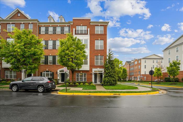 Welcome to this well-maintained end-unit Halley model in the sought-after Loudoun Valley community. With extra windows bringing natural light, thoughtful updates, and low condo fees, this home offers comfort, value, and convenience.This 3 bedroom, 2.5 bathroom home with a finished garage provides the added privacy and brightness that comes with end-unit living. Fresh neutral paint and new flooring on the main level give the home a clean, updated look.The main level features an open floor plan with seamless flow between the living room, dining area, and kitchen, ideal for everyday living and entertaining. The staircase features decorative balusters, creating a more open feel and allowing light to flow throughout the space. The kitchen includes granite countertops, tile backsplash, stainless steel appliances including a gas stove and built-in microwave, plus a large center island with seating.Upstairs, the spacious primary suite features extra windows, a tray ceiling, large walk-in closet, and sliding glass door leading to a covered balcony. The ensuite bath includes dual vanities, upgraded tile, a separate shower, soaking tub, and private water closet.Two additional bedrooms, a full bath with upgraded tile, and a conveniently located washer and dryer complete the upper level.Ideally located just off Loudoun County Parkway and close to schools, the Silver Line Metro, Dulles Airport, hospitals, shopping and dining at Dulles Landing, gyms, movie theater, and Brambleton Town Center.Residents enjoy Loudoun Valley amenities including three clubhouses, fitness centers, swimming pools, tennis courts, basketball courts, tot lots, playgrounds, and walking trails.A bright, updated home in a prime location with low monthly fees!