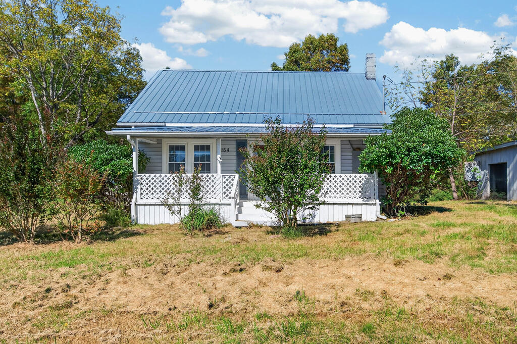 Welcome to 154 Cement Drive! This charming cottage is conveniently located within Galax city limits and offers approximately 8 acres of gently rolling land with endless potential to make it your own. Outside, you'll appreciate the durable metal roof and two-vehicle carport, providing convenient, covered parking. Inside, the home features a cozy, functional layout with two main-level bedrooms, a welcoming living room complete with a wood stove for chilly evenings, and a kitchen with ample cabinet storage and food preparation space. Recent updates include new LVP flooring, fresh paint throughout, and new countertops. Upstairs, you'll find additional space with the potential for a third bedroom, home office, or whatever best suits your needs. To top it all off, the sellers will be installing brand-new mini-split systems prior to settlement! If you're looking for a home to enjoy as-is while gradually adding your own personal touches, this is it! Schedule your showing today!