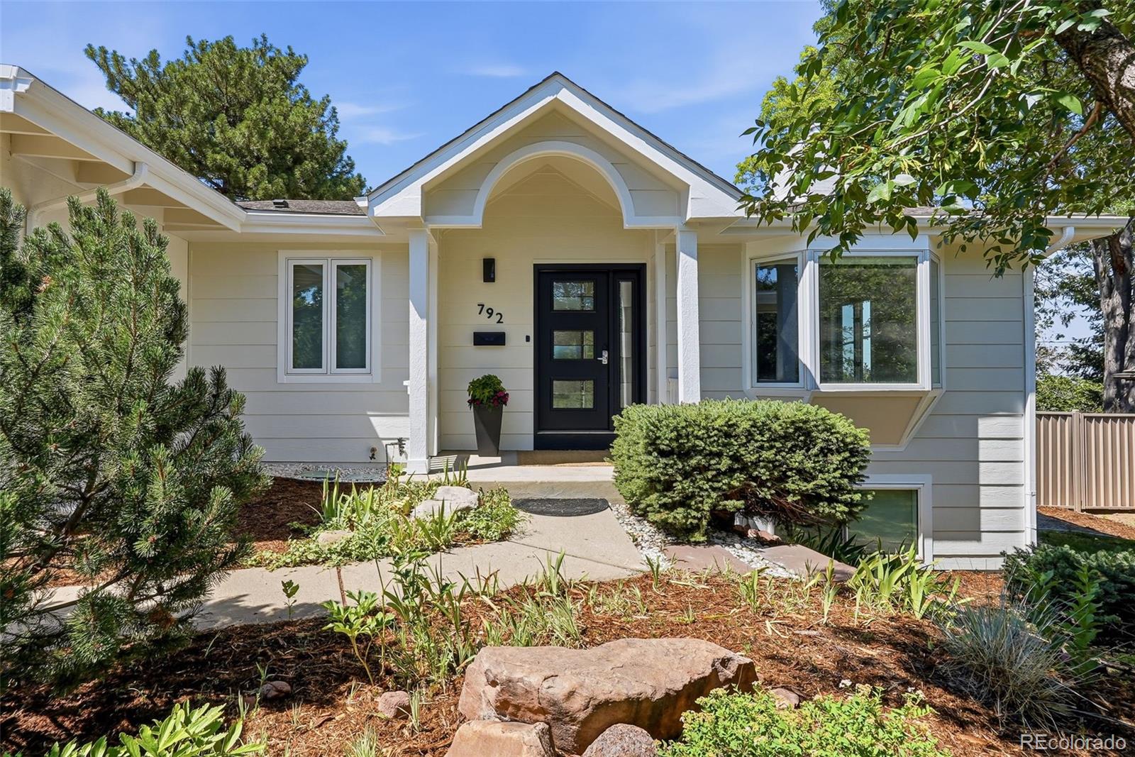 This is your chance to live on one of Table Mesa's most beloved streets! Set on a huge .4 acre lot, this home will WOW you the moment you walk in.  The heart of this home is a truly GREAT room: vaulted ceilings and brilliant natural light create a feeling of expansiveness when you arrive, while stacked stone fireplace anchors the room in coziness, and views of the mountains keep you rooted in Boulder.  Flowing from the great room is a spacious, open kitchen thoughtfully designed with the chef in mind: loads of storage & pantry space, gas range w/vent hood, leathered granite counters with generous prep space and great light from 4 skylights.  An entertainer's dream, with gathering space around the large kitchen island, wet bar w/hot water dispenser and beverage fridge, powder room and plenty of room for guests to mingle, both inside & out. A new Trex deck (with lighting) off the kitchen overlooks the fully fenced private yard. The main-floor primary ensuite has vaulted ceilings and access to deck for those lovely mountain mornings and also features a walk-in closet and 5-piece bath.  Separated from the primary bedroom down their own hallway, are two 2 additional bedrooms & full bath.  The lower level offers a large family room that walks out to patio space & yard.  An adjacent den features a second gas fireplace -- perfect for movie nights, or game day entertaining!  3 large bedrooms, 3/4 bath & dedicated laundry room complete the lower level.  A comprehensive 2016 remodel created fantastic versatility and storage space throughout the home!  With 6 total bedrooms, there’s plenty of options for home office(s), play/craft room, or a home gym!Attached 2-car garage with EV charger and a rare mudroom, complete with built-in cubbies!  Short walk to Bear Creek Elementary, Open Space Trails, Table Mesa restaurants & shops. The perfect combination of light, space & function, in an unbeatable location - this home is truly a *GEM*!