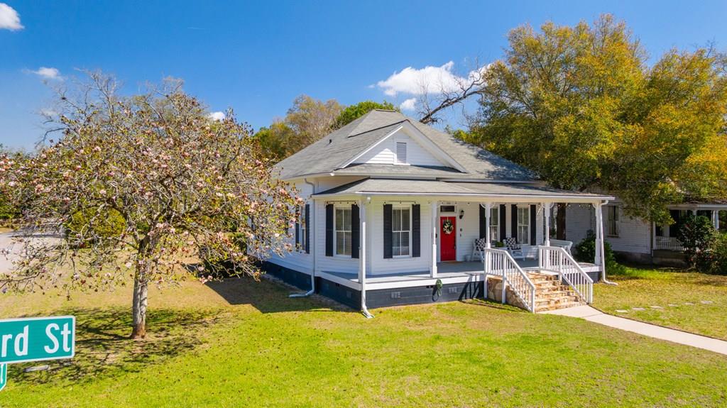 Imagine sitting on the large covered front porch on a cool spring evening in this historic treasure in Thomasville's Dawson St Historic District. Even better, imaging waking to shops and dining in downtown Thomasville. Or, drive a golf cart if that's your pleasure! Step into the old world in the spacious living area with a decorative fireplace, and original hardwood floors. Then, enjoy the best of modern comforts as you step into the large remodeled kitchen. Low maintenance black granite countertops contrast the bright, open faced cabinets, while the stainless appliances round out this chef's paradise. The butler's pantry gives you plenty of space to store your goods, while providing quick and easy access to the living room. The guest bathroom is straight out of southern living with high ceilings, shiplap walls, and an exposed brick wall. All three bedrooms are large, with the front two bedrooms offering decorative fireplaces that can only be found in classic turn-of-the-century homes. The dining room is large and is eager to host family, friends, or business associates. Through the dining room, you will see the incredible in-law suite. It features gorgeous hardwood floors, a well-equipped bathroom, large bedroom, and kitchen/laundry combo. This space could be additional living space for you, a private space for guests, a home for aging in-laws, or even rented for extra income. Outside you have plenty of room to stretch out! The back yard is fenced all the way to the back door of the home, perfect for pets! The two car detached garage is equipped with a Tesla charger, and ready to go! Don't miss this opportunity to own a piece of Thomasville's rich history! Schedule a showing today!