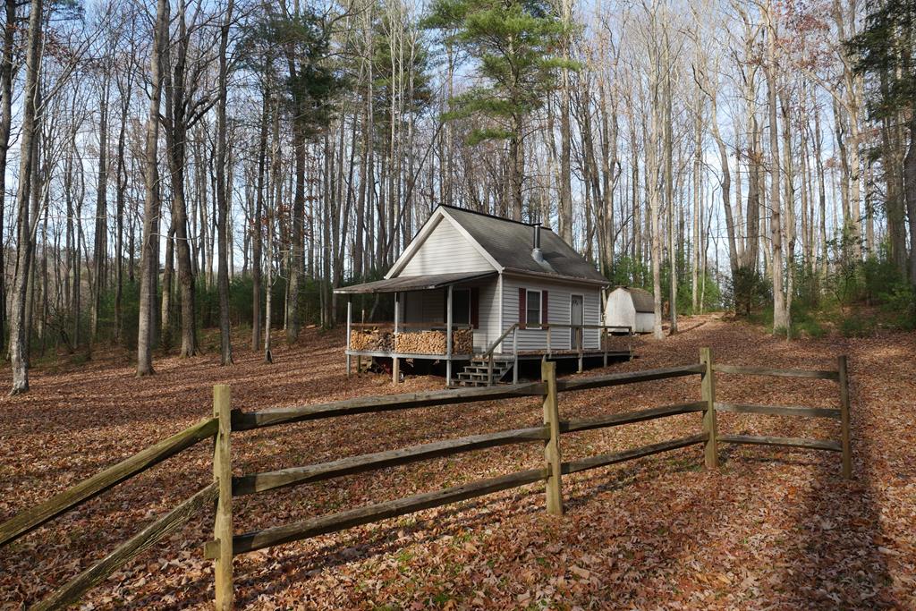 Welcome to your Off-Grid Cabin, situated on over 8 acres in beautiful Southwest Virginia! Nestled in the heart of the Appalachian Mountains, and nearby Mount Rogers/Jefferson National Forest Recreation Area, this cabin provides the private getaway you've been looking for, while being in very close proximity to all the outdoor opportunities in the region! This area has endless hiking, biking, hunting, fishing, camping and horseback riding opportunities. The property around the cabin has relatively gentle topography, with plenty of towering hardwoods for a beautiful summertime canopy! Deer and Turkey will be your neighbors! The small cabin was built in 1999 (per land card) and is a very cozy little hideaway, including a nice deck for relaxing and watching wildlife in your yard! Inside, you will find an open living area with wood burning stove, a small kitchenette with a propane stove, and even a small stand-up shower using the outside holding tank, which is gravity-fed for water pressure. Currently no septic or bathroom, only the outhouse or small "cassette toilet" inside.  Upstairs, you will find a loft area with space for three beds. This could have the potential to become someone's primary residence, or simply a weekend getaway/hunting camp. Nearby attractions include the town of Damascus, dubbed Trail Town USA, and the charming town of Abingdon. Trout fishing? No shortage of native and stocked trout in the numerous mountain streams! Don't miss this rare opportunity! Property is being sold as is; Buyer/Buyer Agent to verify all information.